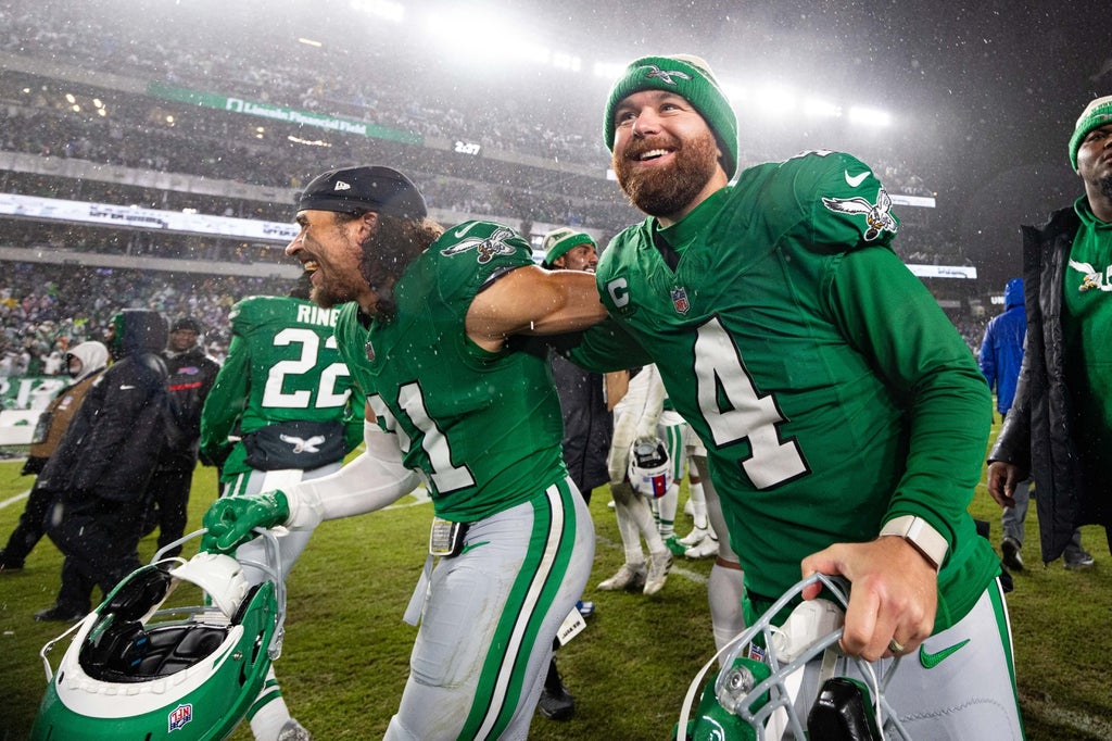 Philadelphia Eagles place kicker Jake Elliott celebrates with safety Sydney Brown after a victory against the Buffalo Bills in overtime at Lincoln Financial Field.