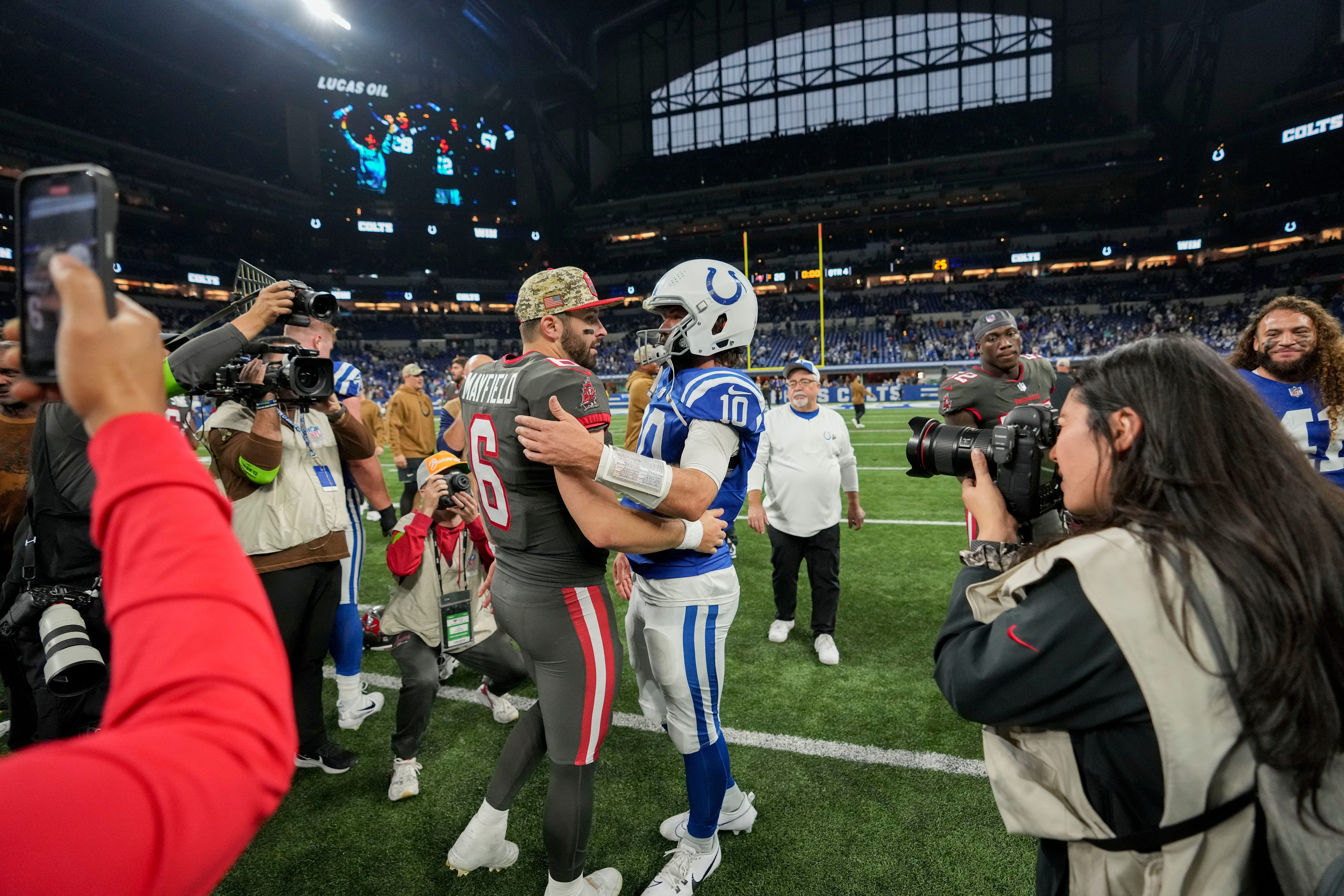 Tampa Bay Buccaneers quarterback Baker Mayfield (6) and Indianapolis Colts quarterback Gardner Minshew II (10) meet on the field Sunday, Nov. 26, 2023, after a game against the Tampa Bay Buccaneers at Lucas Oil Stadium in Indianapolis.