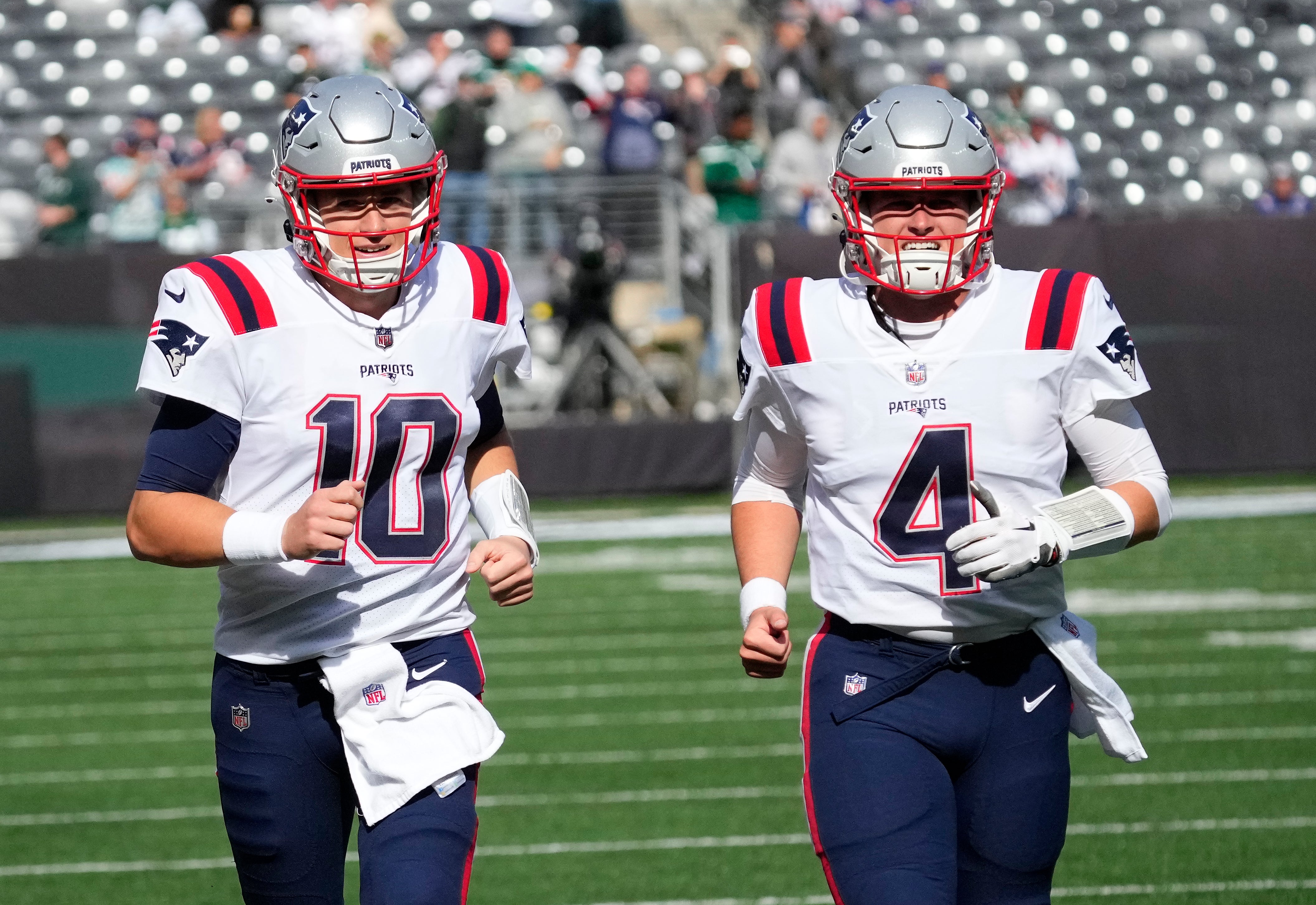 New England Patriots quarterbacks Mac Jones  and Bailey Zappe warm up before the game against the New York Jets at MetLife Stadium