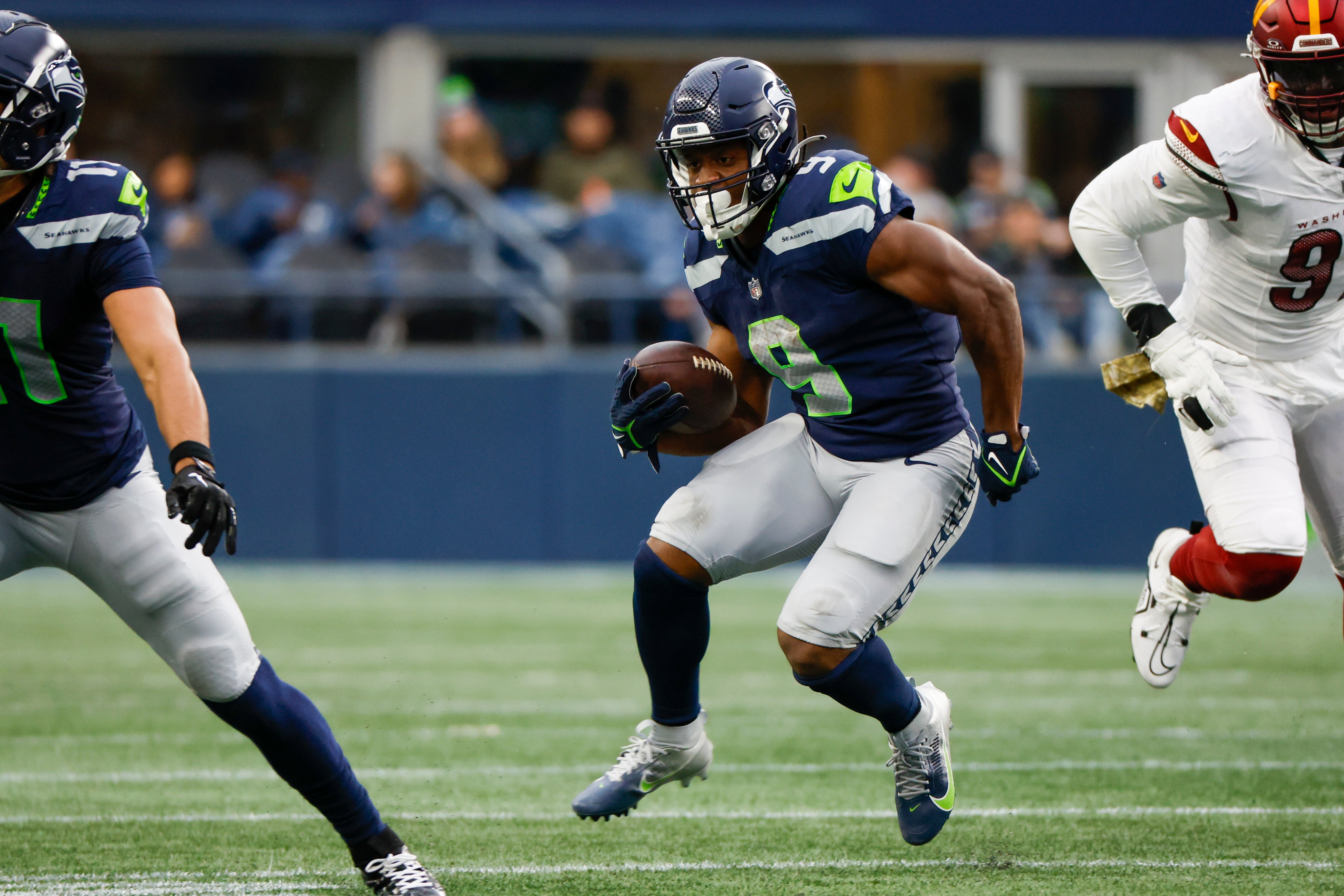 Nov 12, 2023; Seattle, Washington, USA; Seattle Seahawks running back Kenneth Walker III (9) rushes against the Washington Commanders during the second quarter at Lumen Field.
