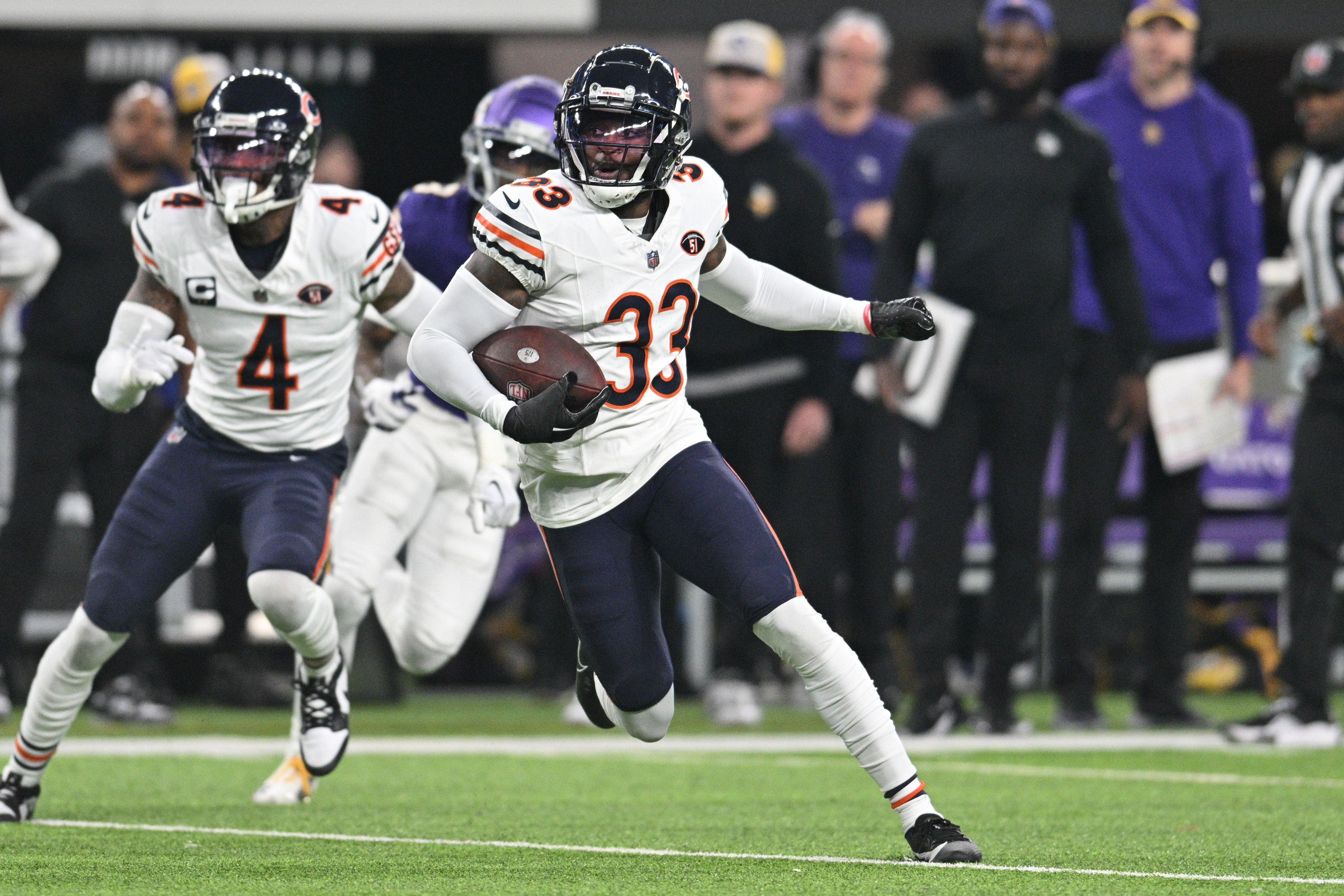 Nov 27, 2023; Minneapolis, Minnesota, USA; Chicago Bears cornerback Jaylon Johnson (33) returns an interception as safety Eddie Jackson (4) looks on against the Minnesota Vikings during the second quarter at U.S. Bank Stadium.