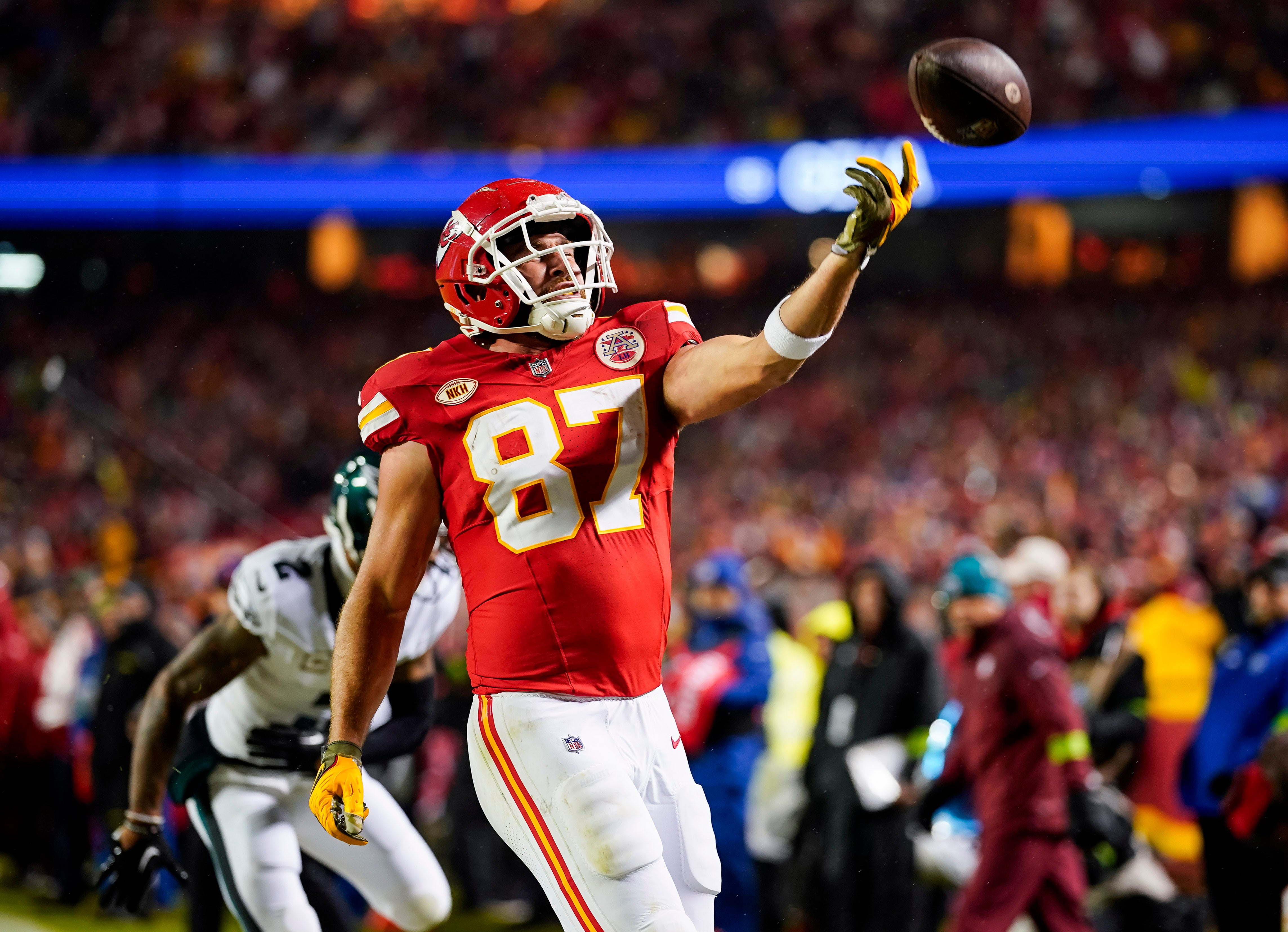 Nov 20, 2023; Kansas City, Missouri, USA; Kansas City Chiefs tight end Travis Kelce (87) tosses the ball after scoring a touchdown against Philadelphia Eagles cornerback Darius Slay (2) during the first half at GEHA Field at Arrowhead Stadium. Mandatory Credit: Jay Biggerstaff-USA TODAY Sports