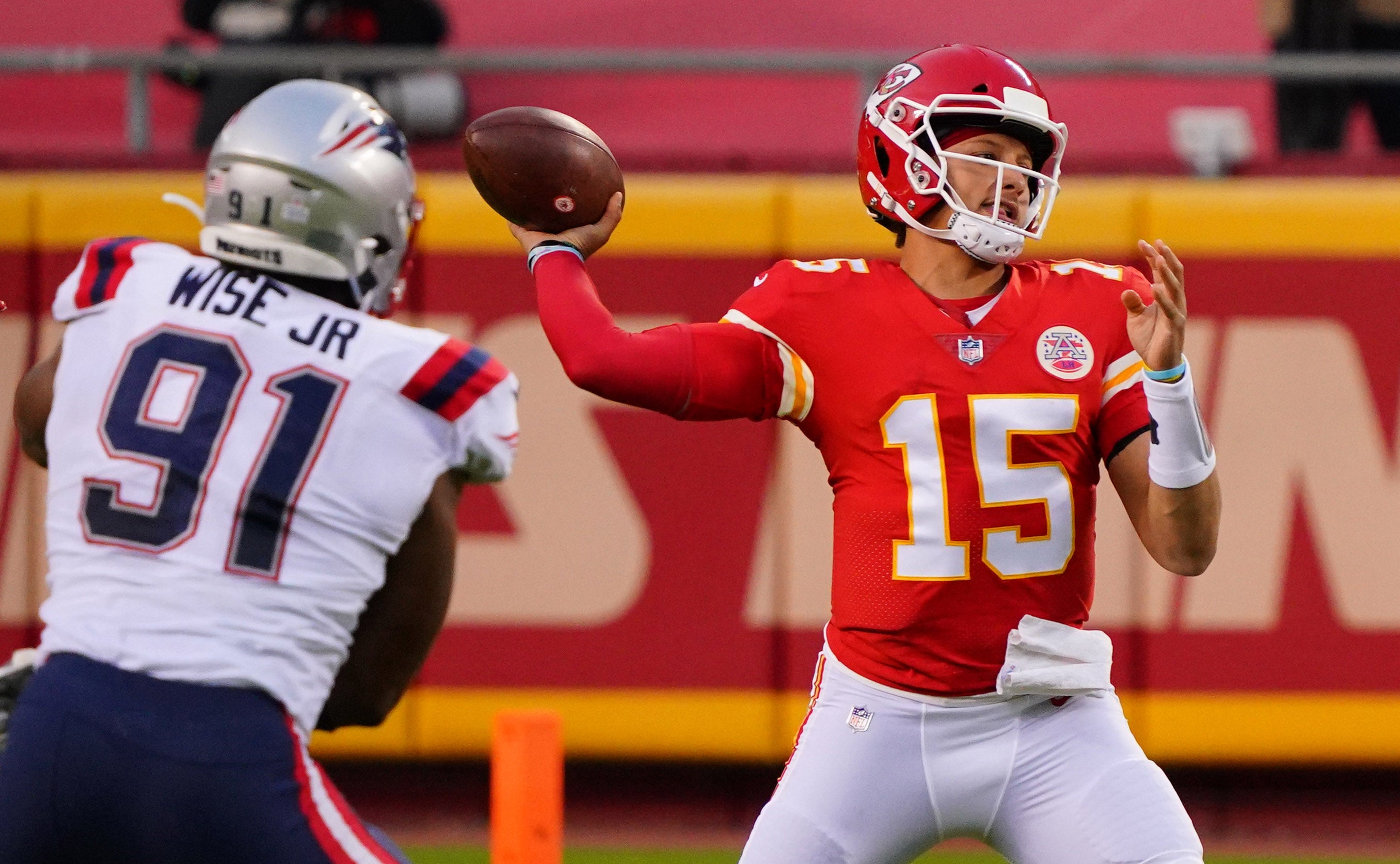 Kansas City Chiefs quarterback Patrick Mahomes throws a pass against New England Patriots defensive end Deatrich Wise during the first quarter of a NFL game at Arrowhead Stadium