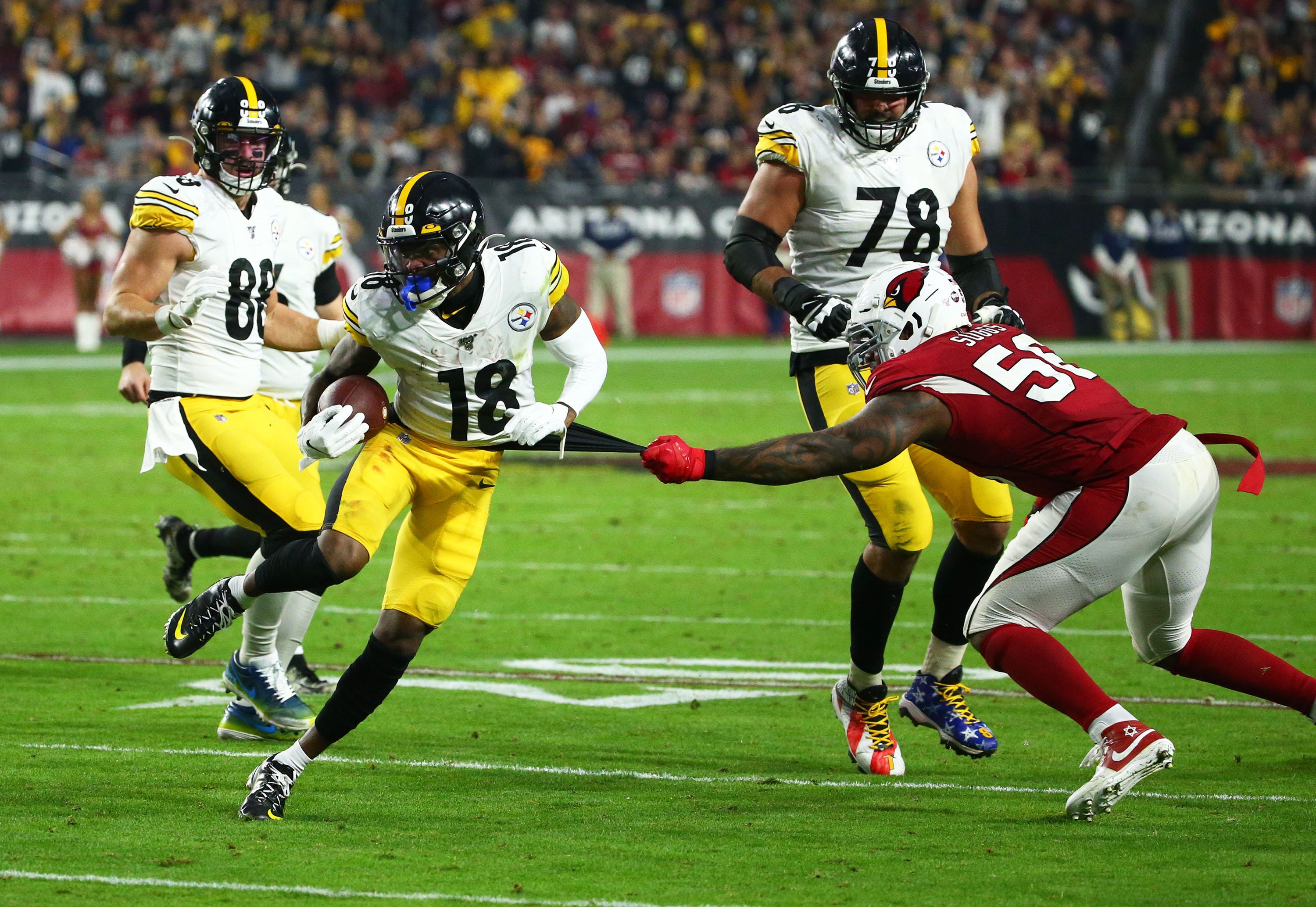 Arizona Cardinals outside linebacker Terrell Suggs (56) tries to tackle Pittsburgh Steelers wide receiver Diontae Johnson (18) in the second half during a game on Dec. 8, 2019 in Glendale, Arizona. Pittsburgh Steelers Vs Arizona Cardinals 2019  