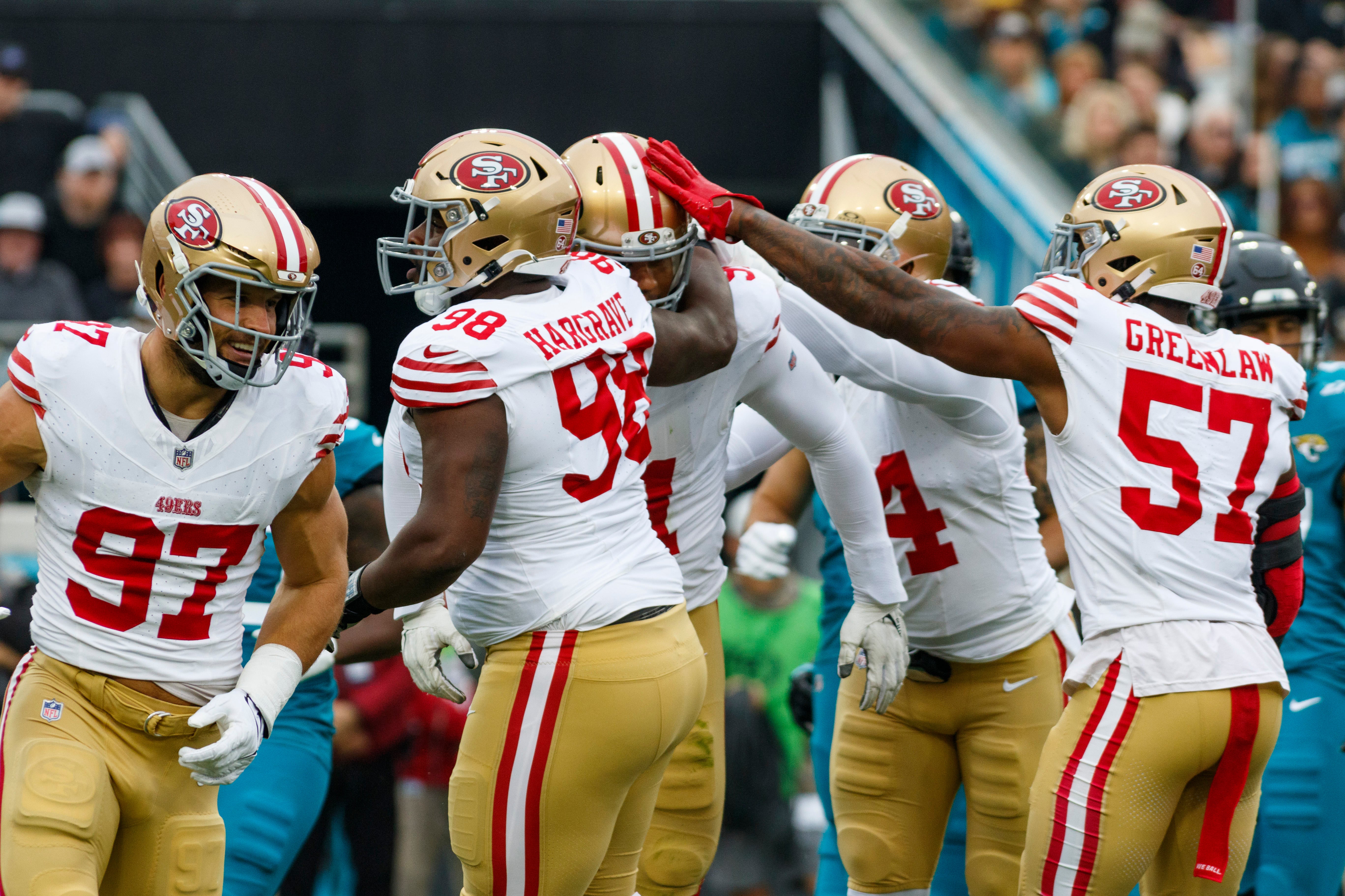 Nov 12, 2023; Jacksonville, Florida, USA; San Francisco 49ers defensive tackle Arik Armstead (91), defensive tackle Nick Bosa (97), defensive tackle Javon Hargrave (98), offensive tackle Spencer Burford (74) and linebacker Dee Greenlaw (57) celebrate a sack against the Jacksonville Jaguars during the first quarter at EverBank Stadium.