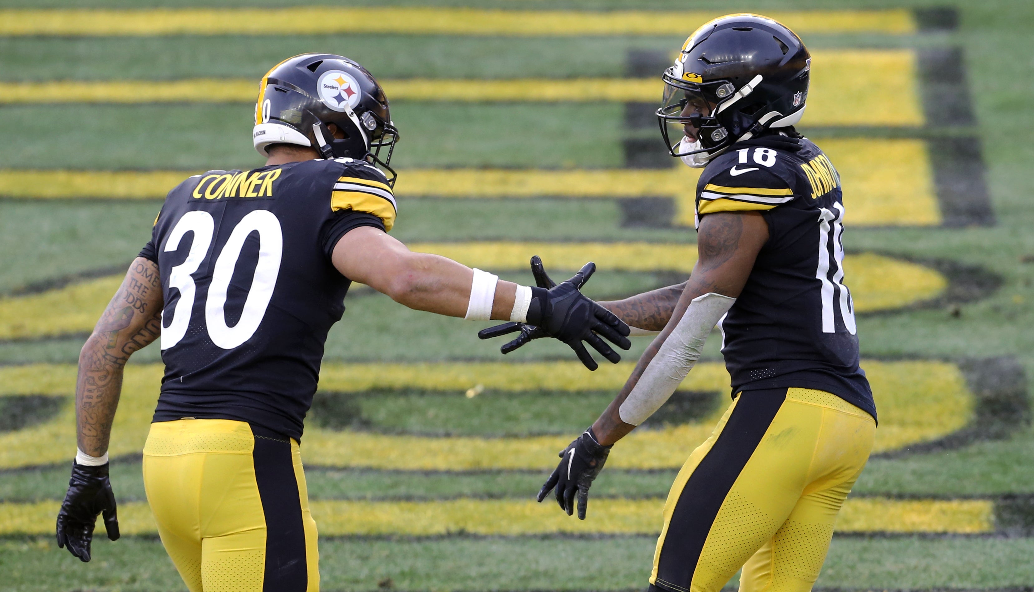 Dec 27, 2020; Pittsburgh, Pennsylvania, USA; Pittsburgh Steelers running back James Conner (30) congratulates wide receiver Diontae Johnson (18) after his touchdown against the Indianapolis Colts during the third quarter at Heinz Field. Mandatory Credit: Charles LeClaire-USA TODAY Sports