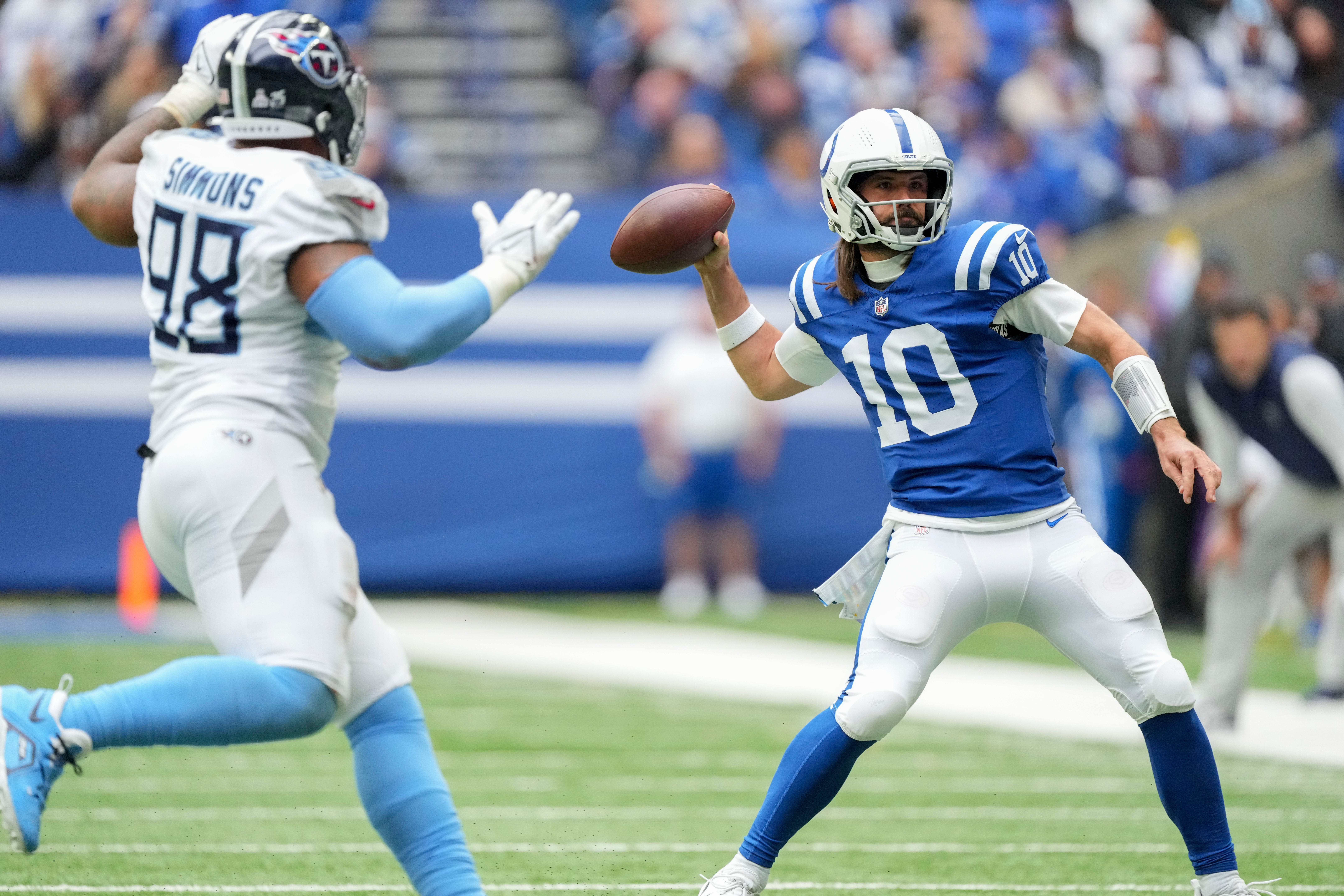 Indianapolis Colts quarterback Gardner Minshew (10) draws back to pass as Tennessee Titans defensive tackle Jeffery Simmons (98) moves in Sunday, Oct. 8, 2023, during a game against the Tennessee Titans at Lucas Oil Stadium in Indianapolis.