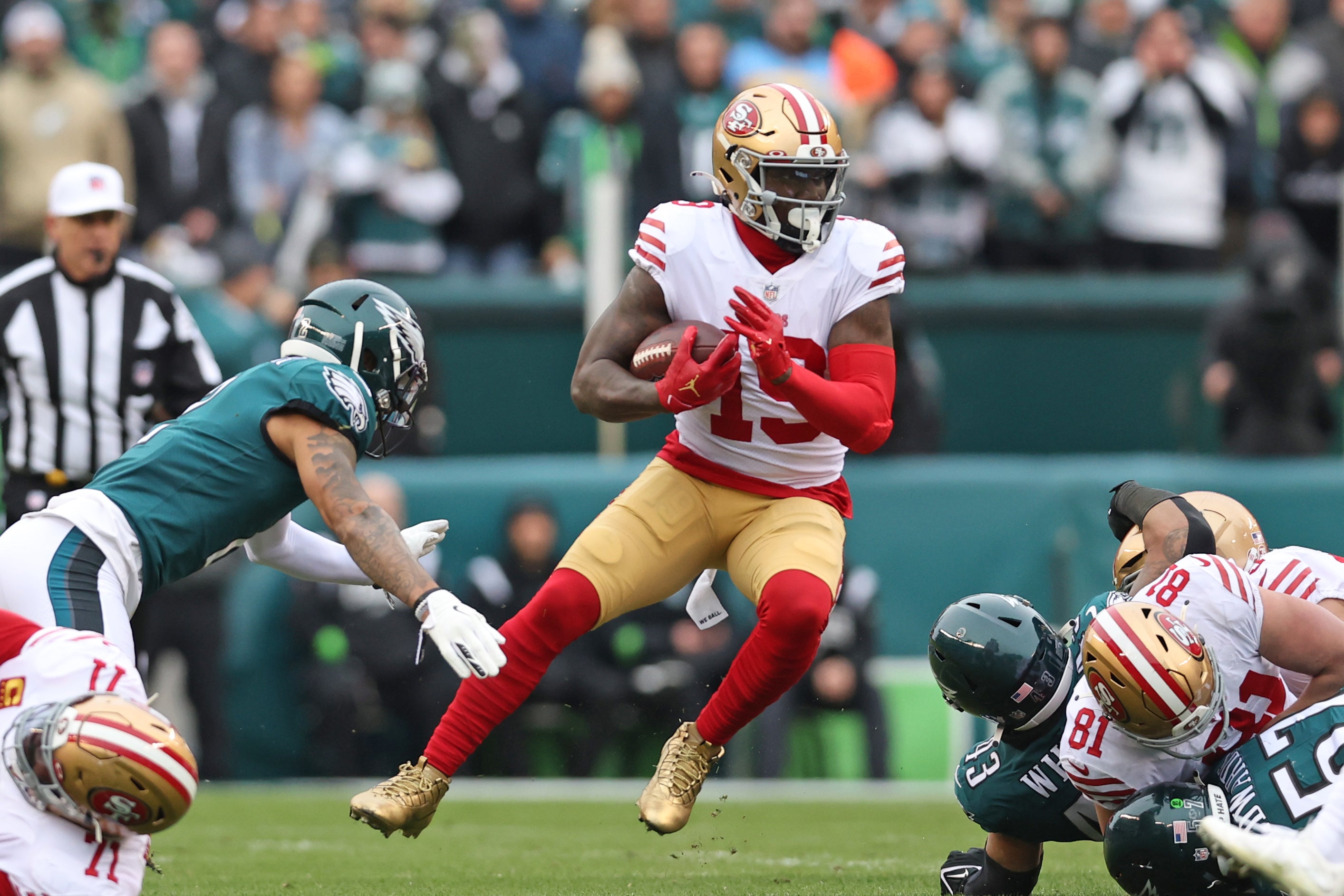 Jan 29, 2023; Philadelphia, Pennsylvania, USA; San Francisco 49ers wide receiver Deebo Samuel (19) looks for room to run against the Philadelphia Eagles during the first quarter in the NFC Championship game at Lincoln Financial Field.