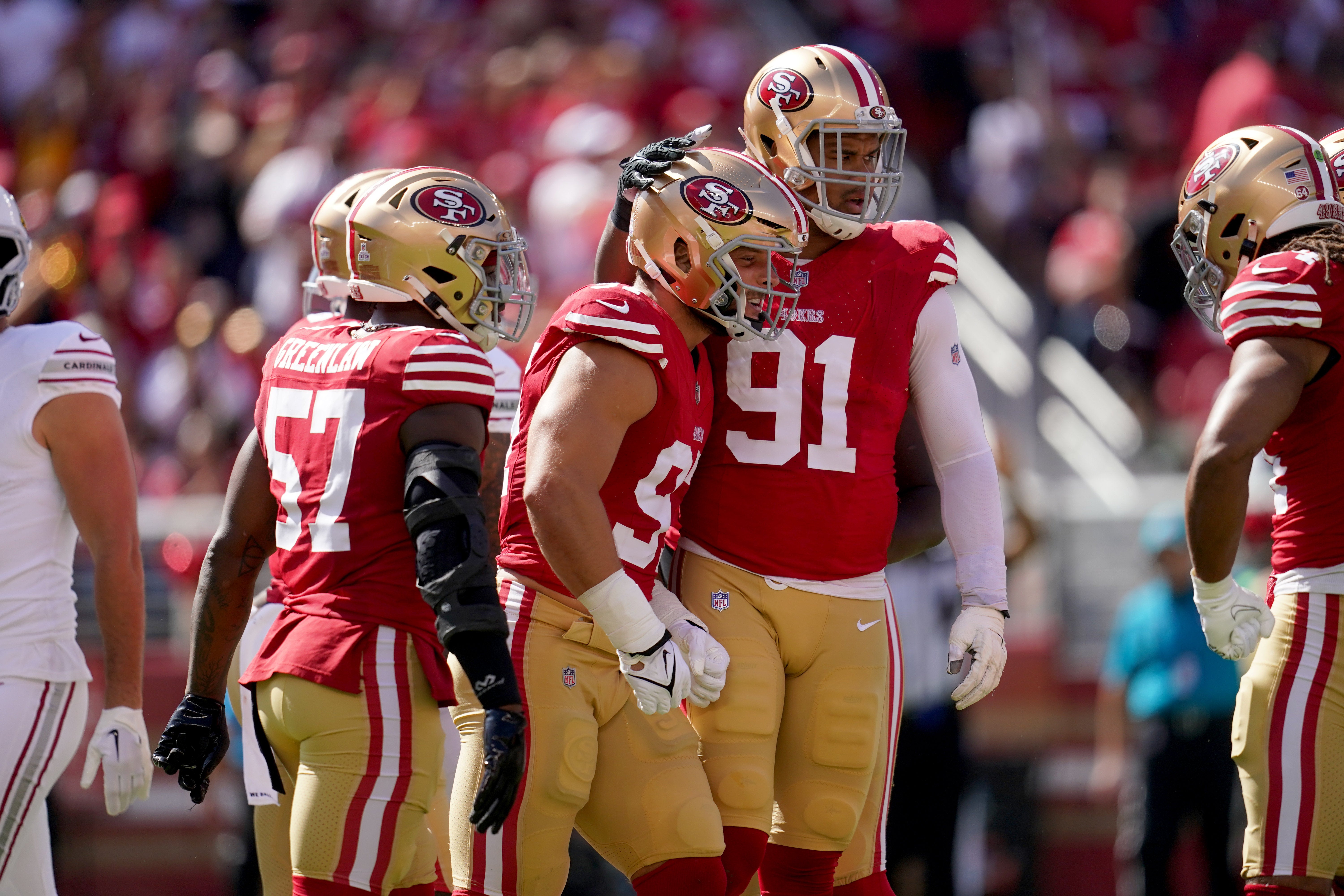 Oct 1, 2023; Santa Clara, California, USA; San Francisco 49ers defensive end Nick Bosa (97) is congratulated by defensive end Arik Armstead (91) after making a tackle against the Arizona Cardinals in the first quarter at Levi's Stadium.