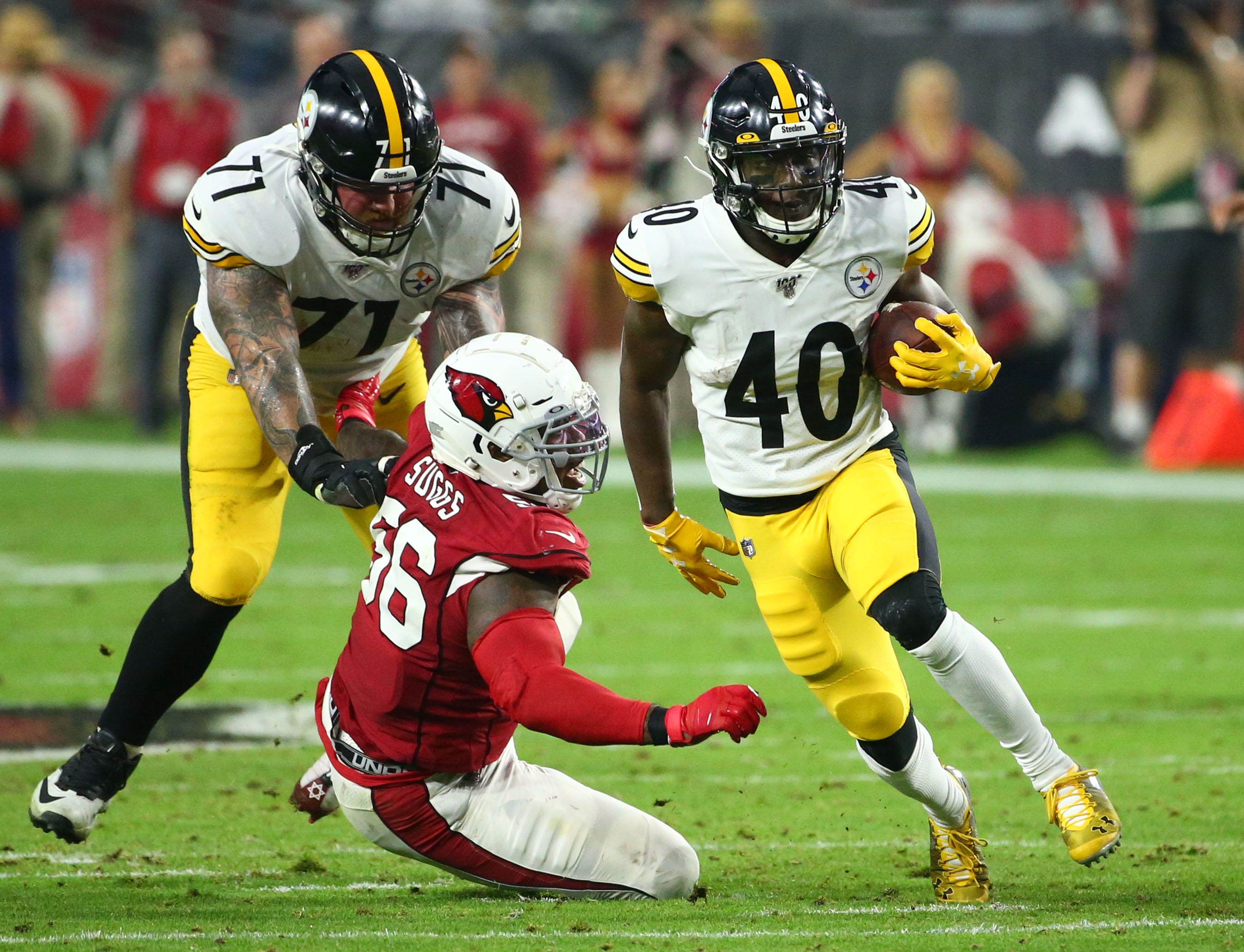 Pittsburgh Steelers running back Kerrith Whyte (40) runs past Arizona Cardinals outside linebacker Terrell Suggs (56) in the first half during a game on Dec. 8, 2019 in Glendale, Arizona. Pittsburgh Steelers Vs Arizona Cardinals 2019
