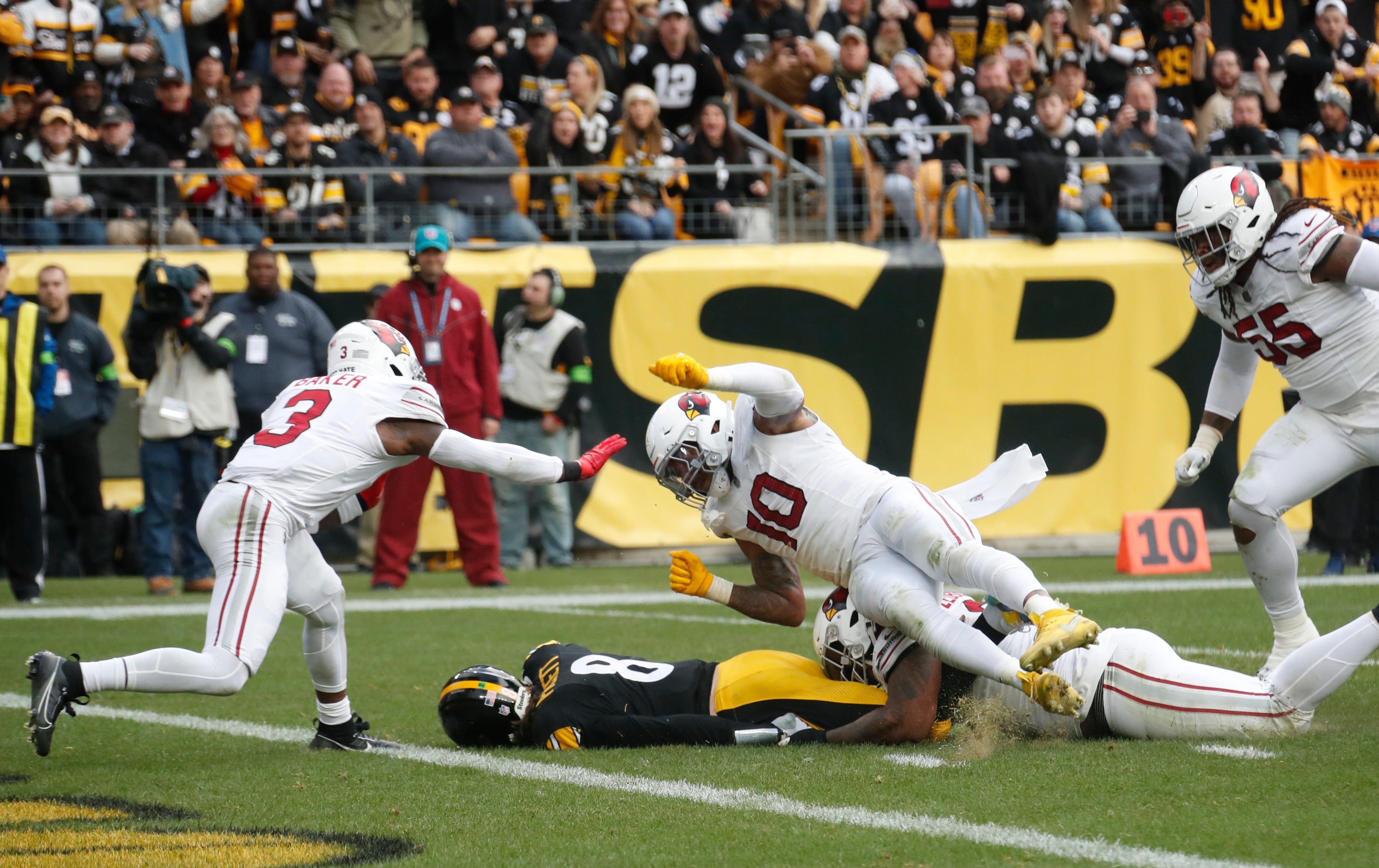 Dec 3, 2023; Pittsburgh, Pennsylvania, USA; Pittsburgh Steelers quarterback Kenny Pickett (8) runs the ball as Arizona Cardinals defensive end Jonathan Ledbetter (93) and linebacker Josh Woods (10) tackle during the second quarter at Acrisure Stadium. Mandatory Credit: Charles LeClaire-USA TODAY Sports