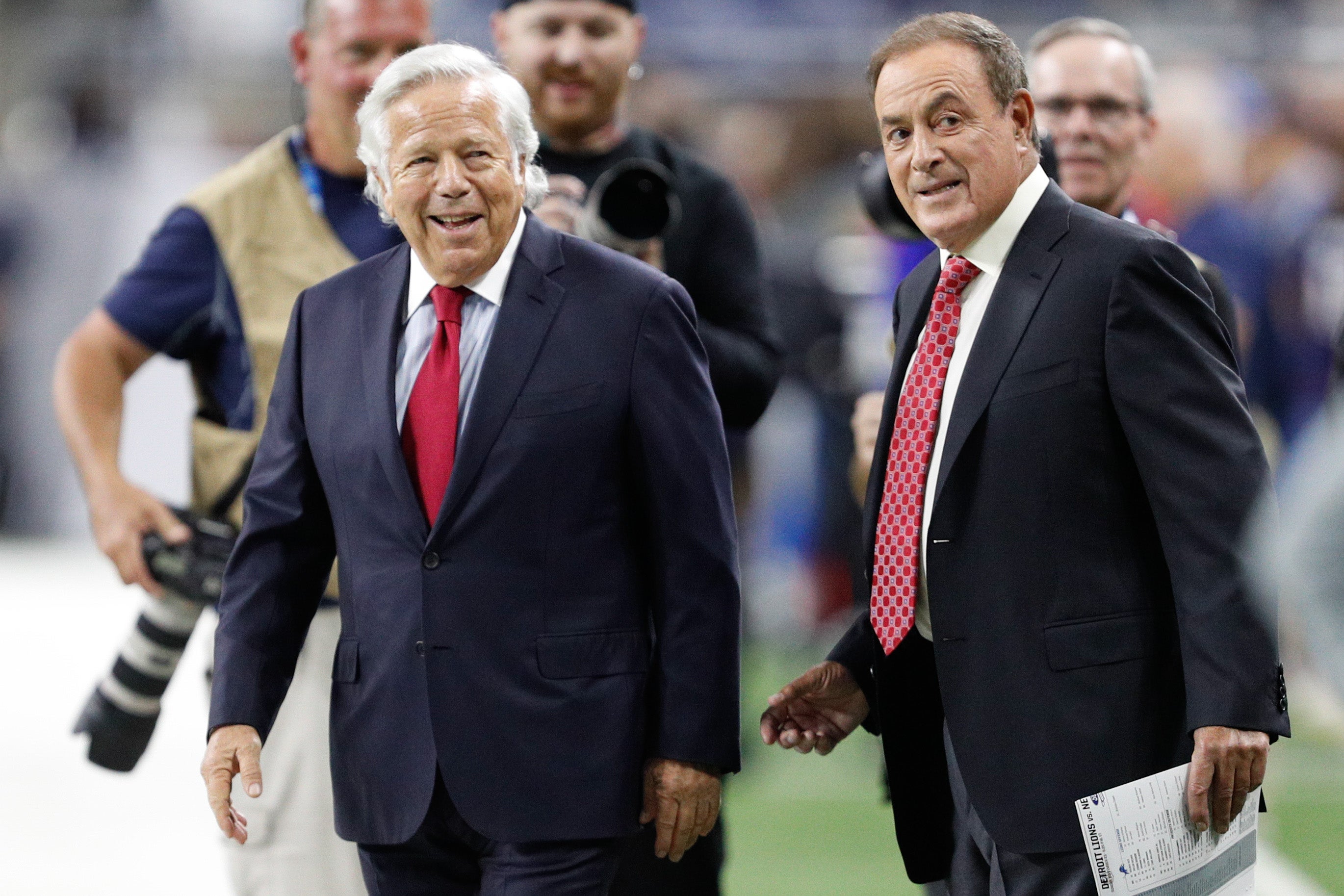 New England Patriots owner Robert Kraft smiles beside sportscaster Al Michaels before the game against the Detroit Lions at Ford Field.