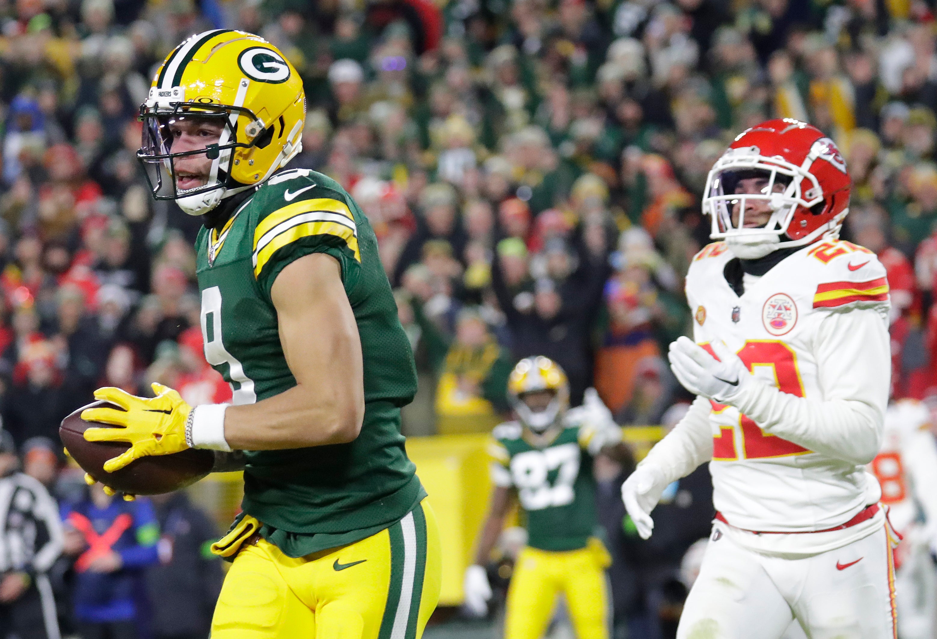 Dec 3, 2023; Green Bay, Wisconsin, USA; Green Bay Packers wide receiver Christian Watson (9) scores a touchdown against Kansas City Chiefs cornerback Trent McDuffie (22) at Lambeau Field.