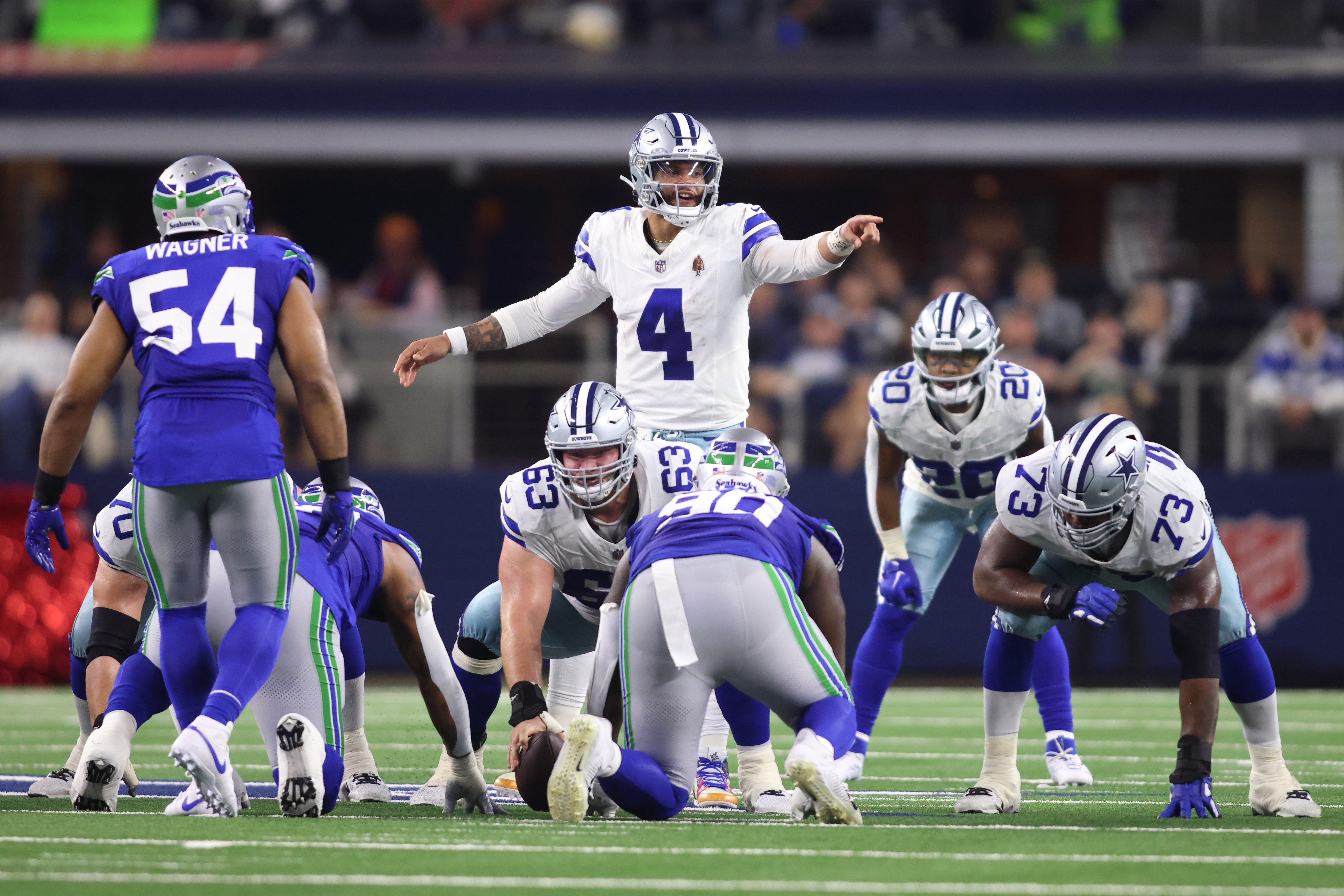Dallas Cowboys quarterback Dak Prescott (4) gestures at the line of scrimmage during the first half against the Seattle Seahawks at AT&T Stadium.