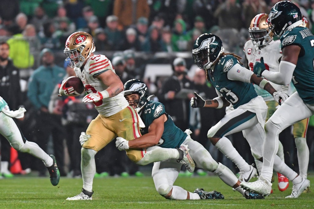 San Francisco 49ers running back Christian McCaffrey (23) is tackled by Philadelphia Eagles linebacker Christian Elliss (53) against the Philadelphia Eagles during the third quarter.