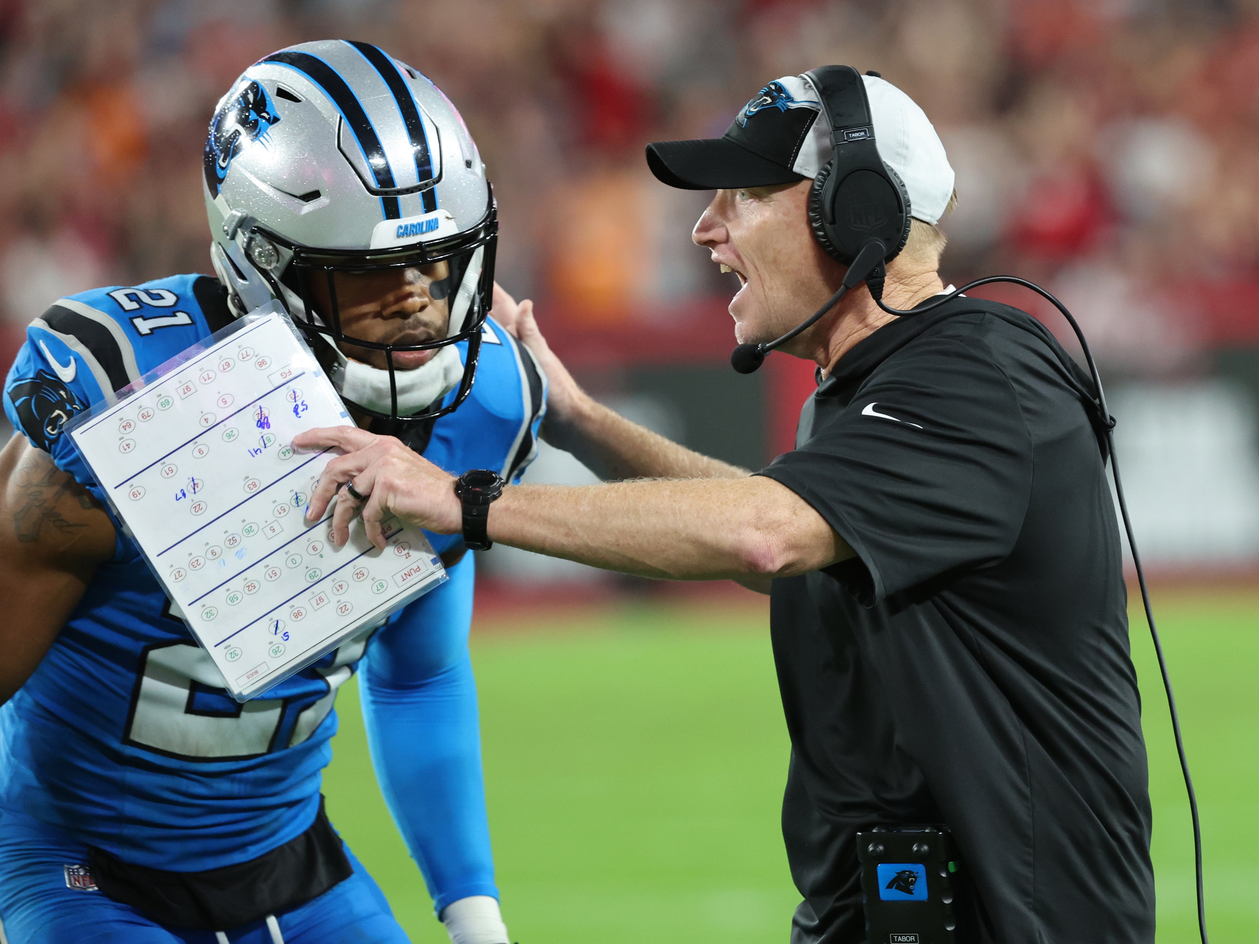 Dec 3, 2023; Tampa, Florida, USA; Carolina Panthers interim head coach Chris Tabor talks with safety Jeremy Chinn (21) against the Tampa Bay Buccaneers during the second half at Raymond James Stadium.