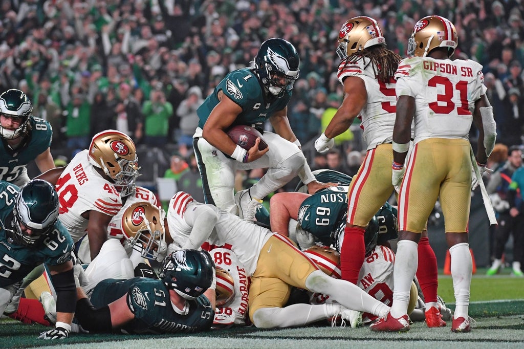 Philadelphia Eagles quarterback Jalen Hurts scores a touchdown against the San Francisco 49ers during the third quarter at Lincoln Financial Field.