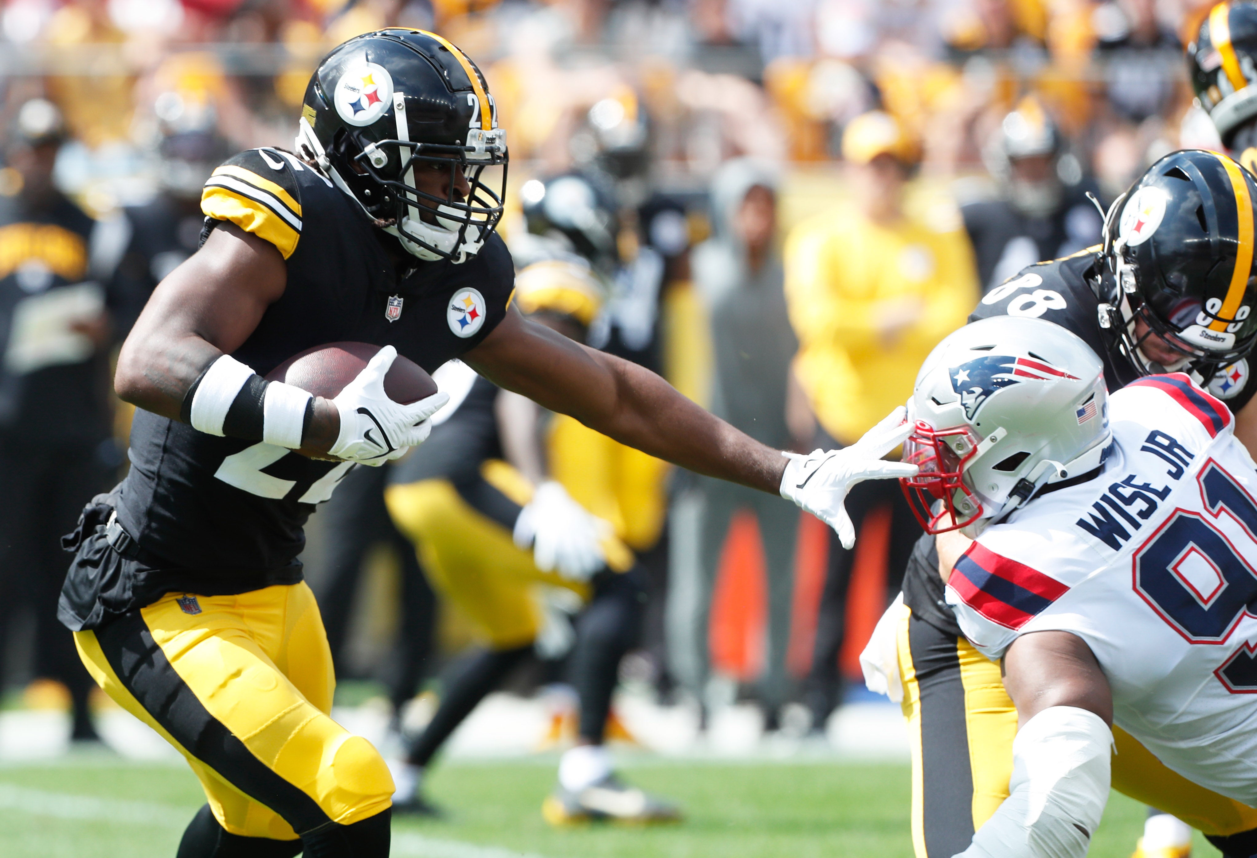 Sep 18, 2022; Pittsburgh, Pennsylvania, USA; Pittsburgh Steelers running back Najee Harris (22) runs the ball against New England Patriots defensive end Deatrich Wise Jr. (91) during the first quarter at Acrisure Stadium. Mandatory Credit: Charles LeClaire-USA TODAY Sports