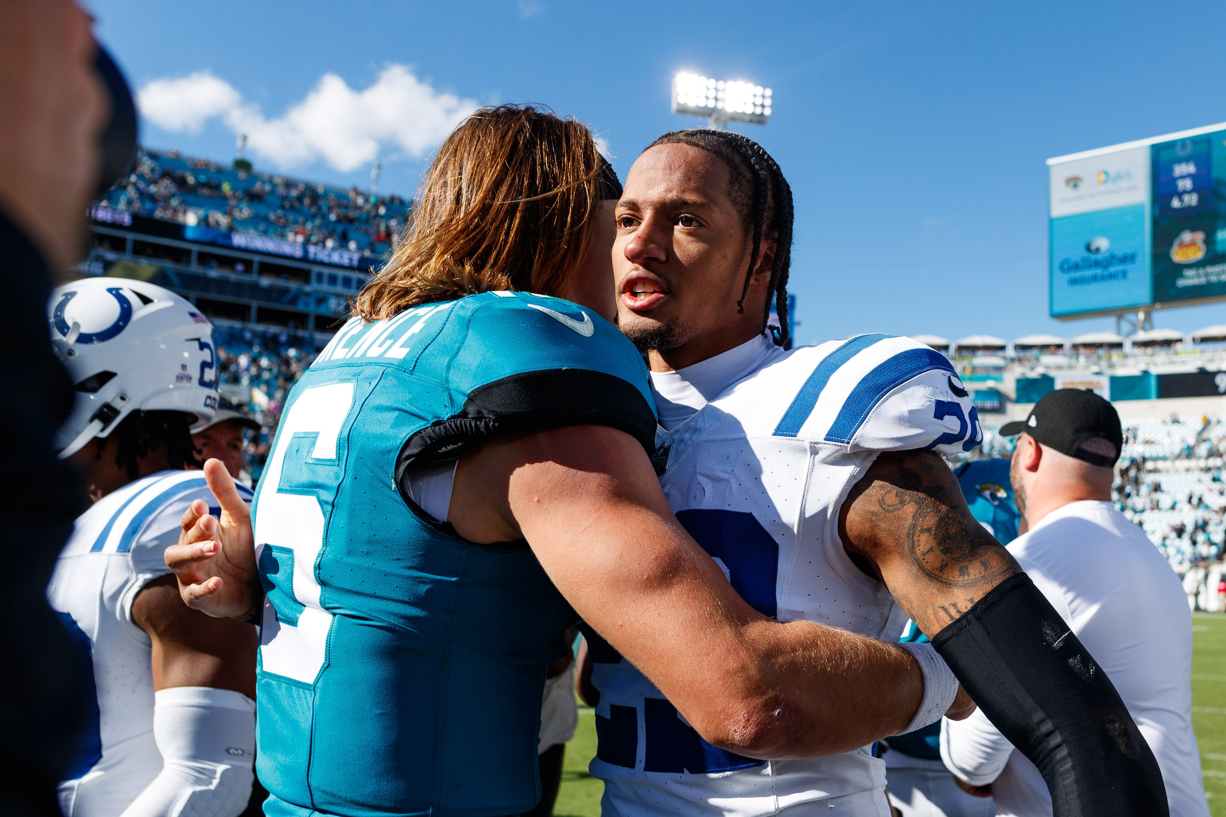 Oct 15, 2023; Jacksonville, Florida, USA; Jacksonville Jaguars quarterback Trevor Lawrence (16) and Indianapolis Colts cornerback JuJu Brents (29) after the game at EverBank Stadium.