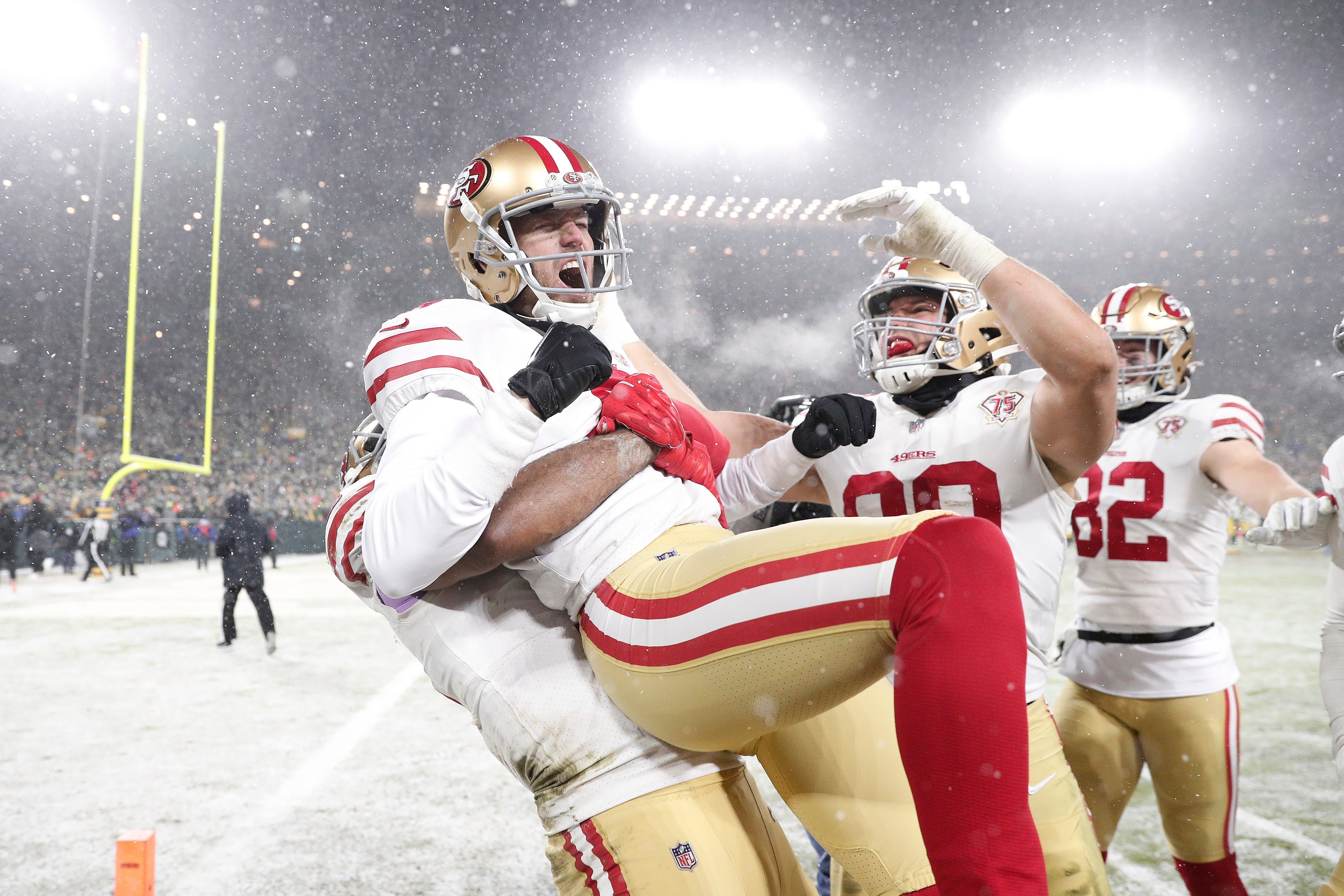 Jan 22, 2022; Green Bay, Wisconsin, USA; San Francisco 49ers kicker Robbie Gould (9) celebrates with teammate after kicking the game winning field goal during a NFC Divisional playoff football game against the Green Bay Packers at Lambeau Field.