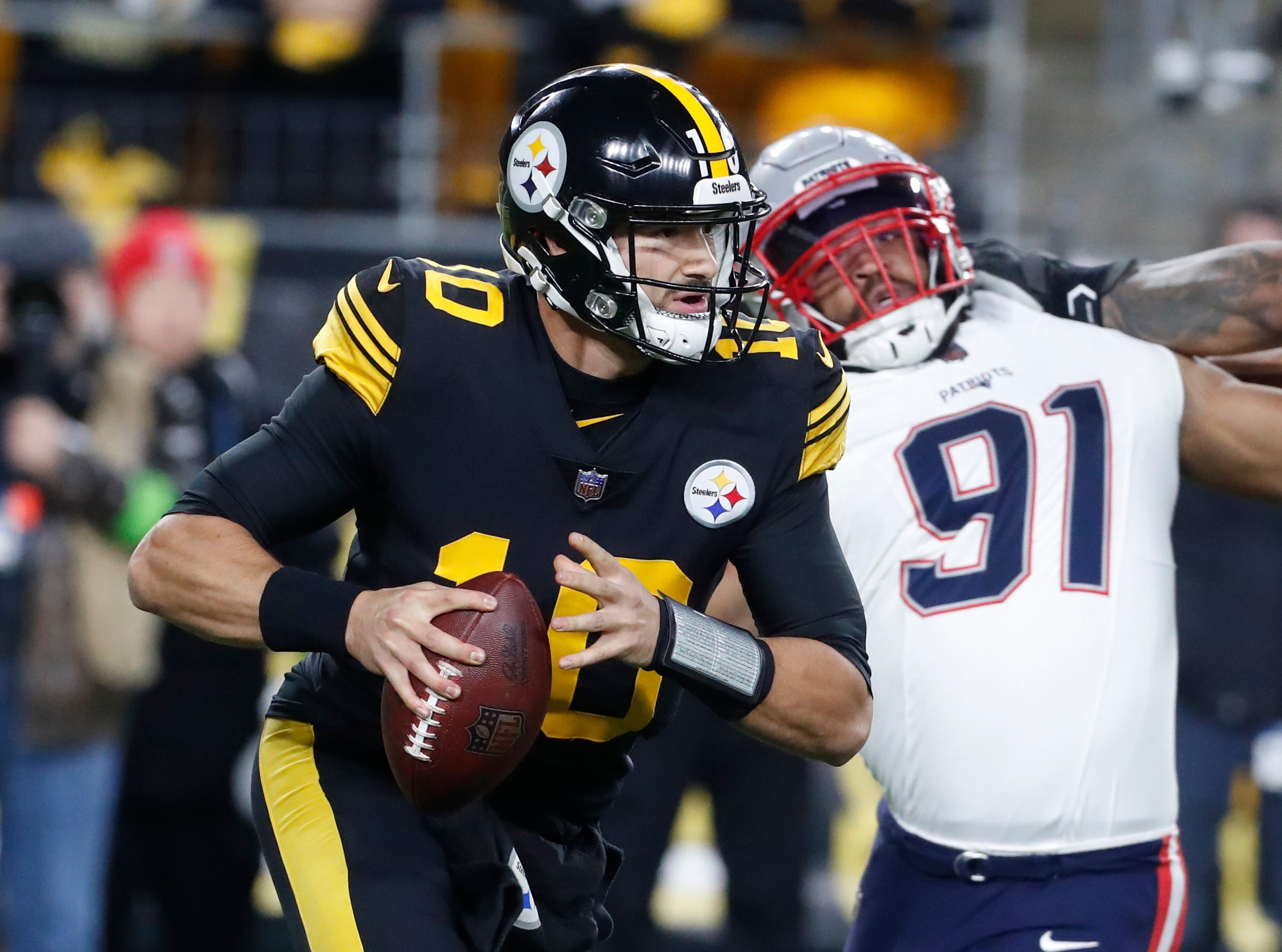 Dec 7, 2023; Pittsburgh, Pennsylvania, USA; Pittsburgh Steelers quarterback Mitch Trubisky (10) scrambles with the ball against the New England Patriots during the first quarter at Acrisure Stadium. Mandatory Credit: Charles LeClaire-USA TODAY Sports