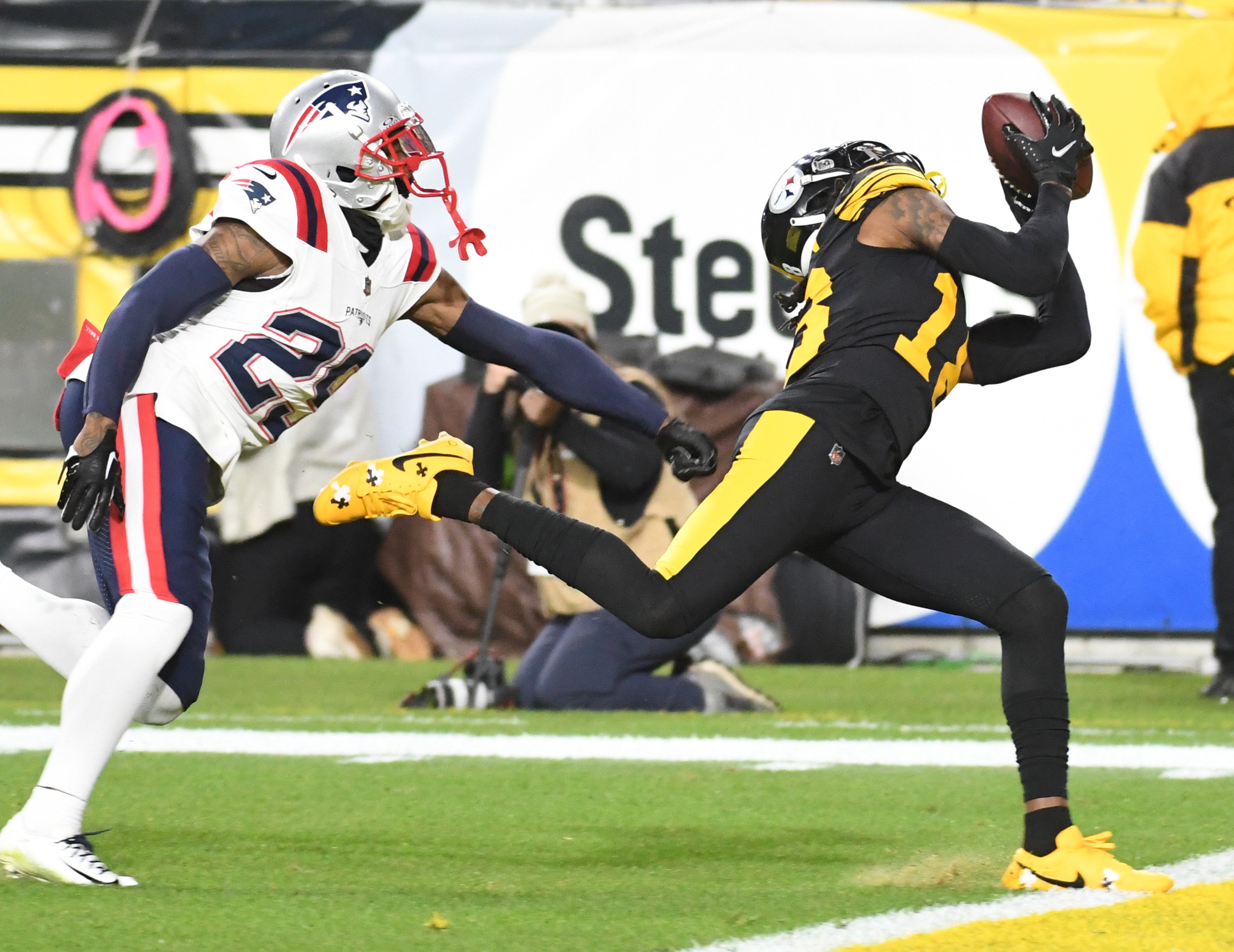 Dec 7, 2023; Pittsburgh, Pennsylvania, USA; Pittsburgh Steelers wide receiver Diontae Johnson (18) makes a touchdown catch by while defended by New England Patriots cornerback J.C. Jackson (29) during the second quarter at Acrisure Stadium. Mandatory Credit: Philip G. Pavely-USA TODAY Sports  