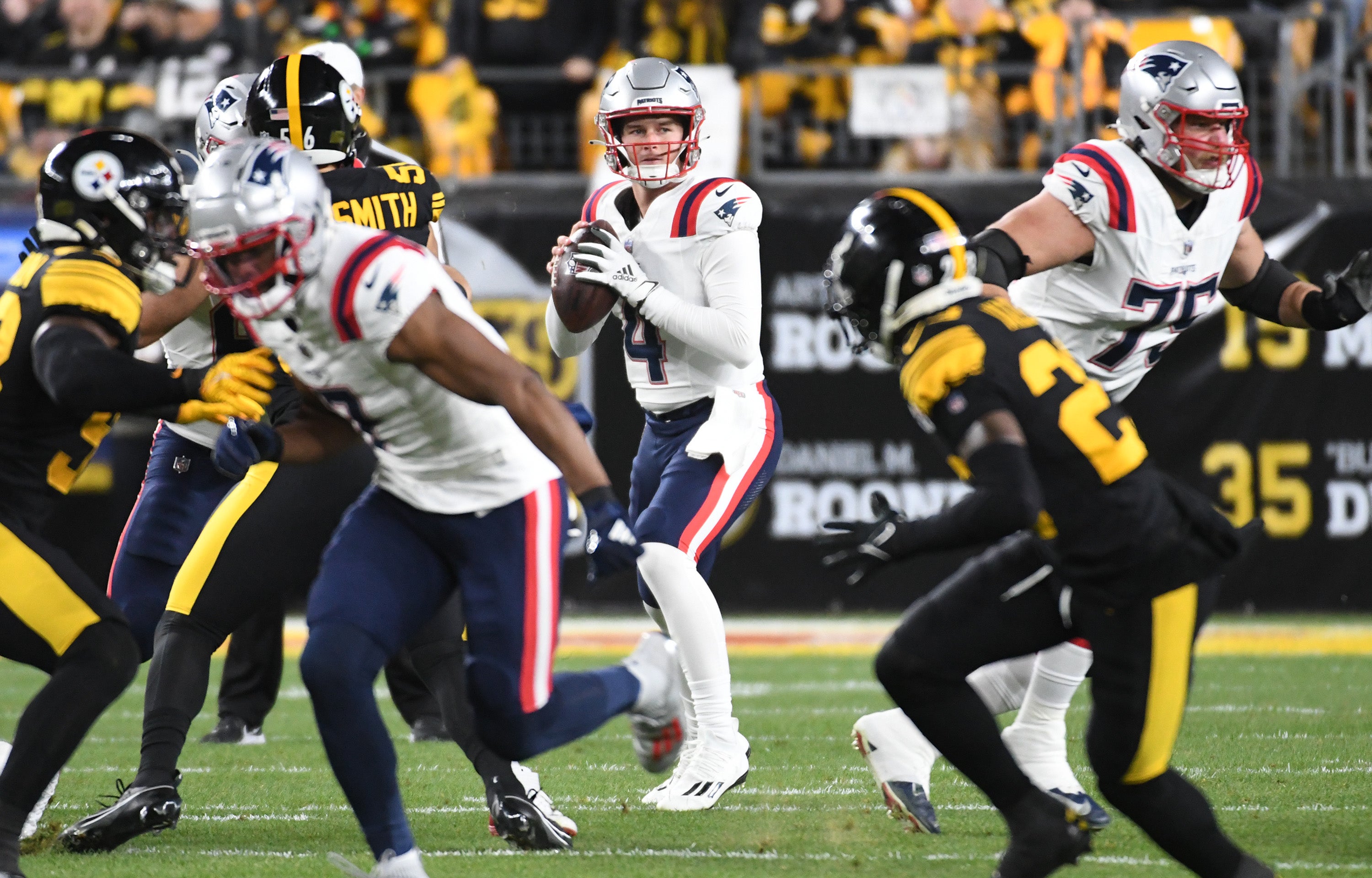 New England Patriots quarterback Bailey Zappe looks for a receiver against the Pittsburgh Steelers during the first quarter at Acrisure Stadium.