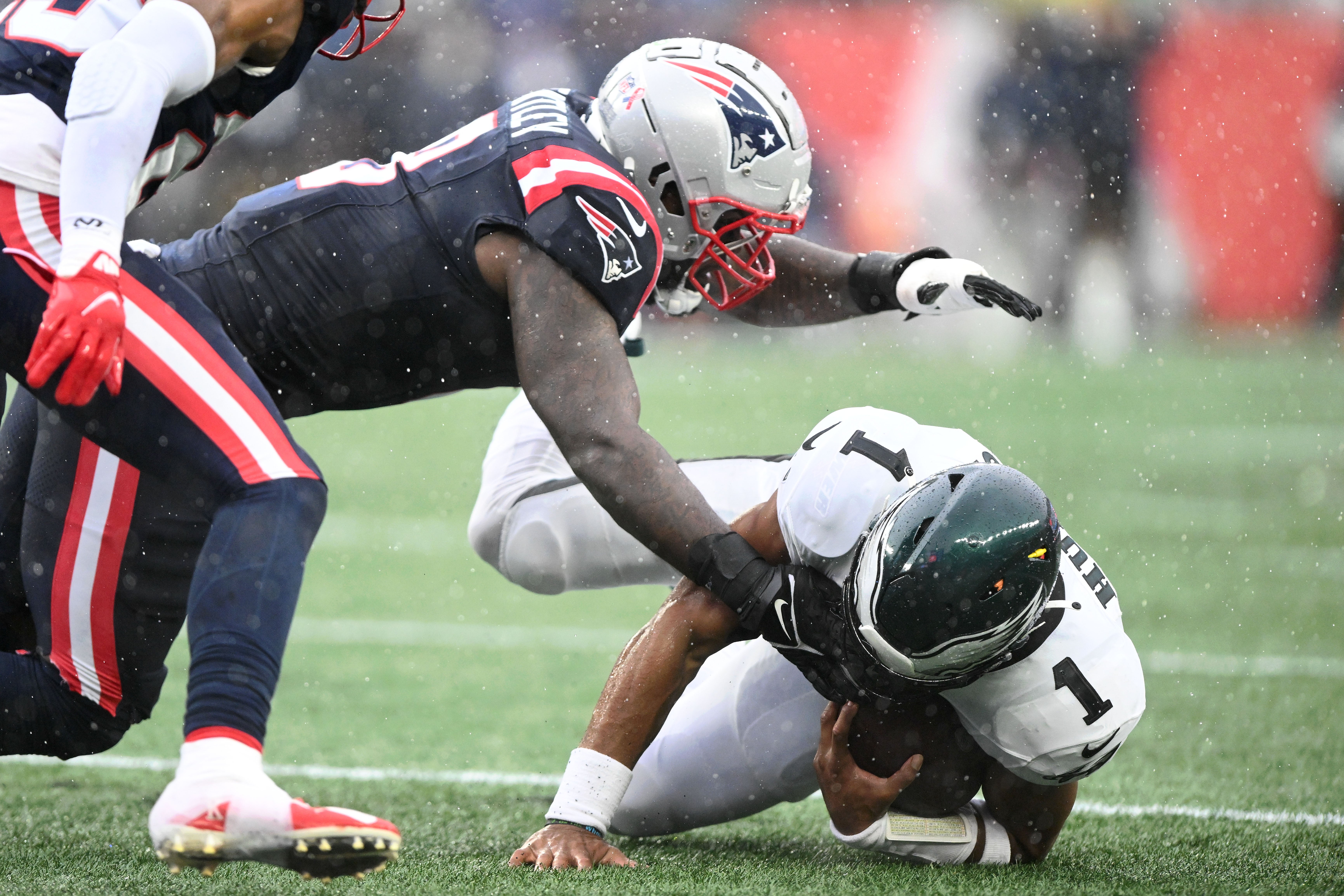 New England Patriots linebacker Ja'Whaun Bentley tackles Philadelphia Eagles quarterback Jalen Hurts during the first half at Gillette Stadium