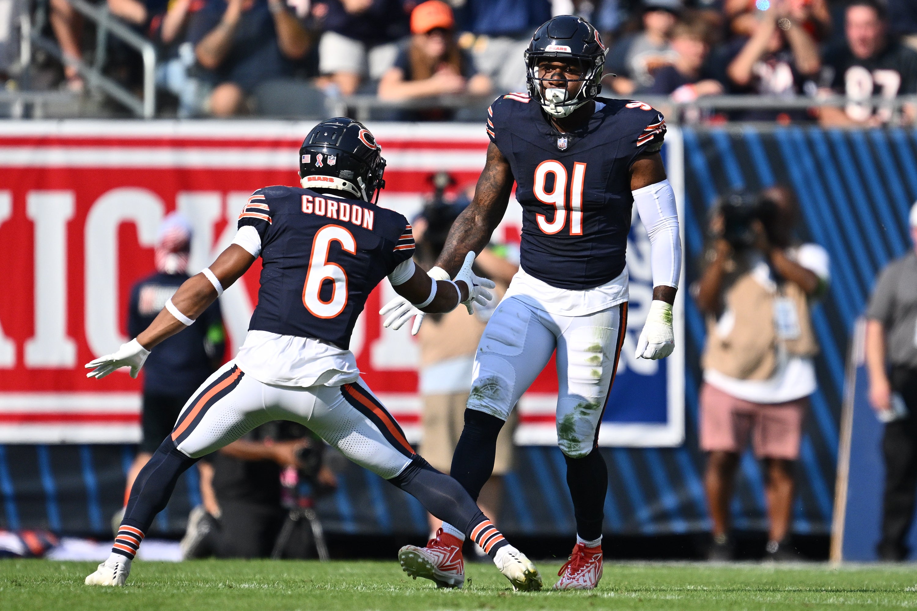 Sep 10, 2023; Chicago, Illinois, USA; Chicago Bears defensive lineman Yannick Ngakoue (91) celebrates with defensive back Kyler Gordon (6) after dropping the Green Bay Packers ballcarrier for a loss in the first half at Soldier Field.