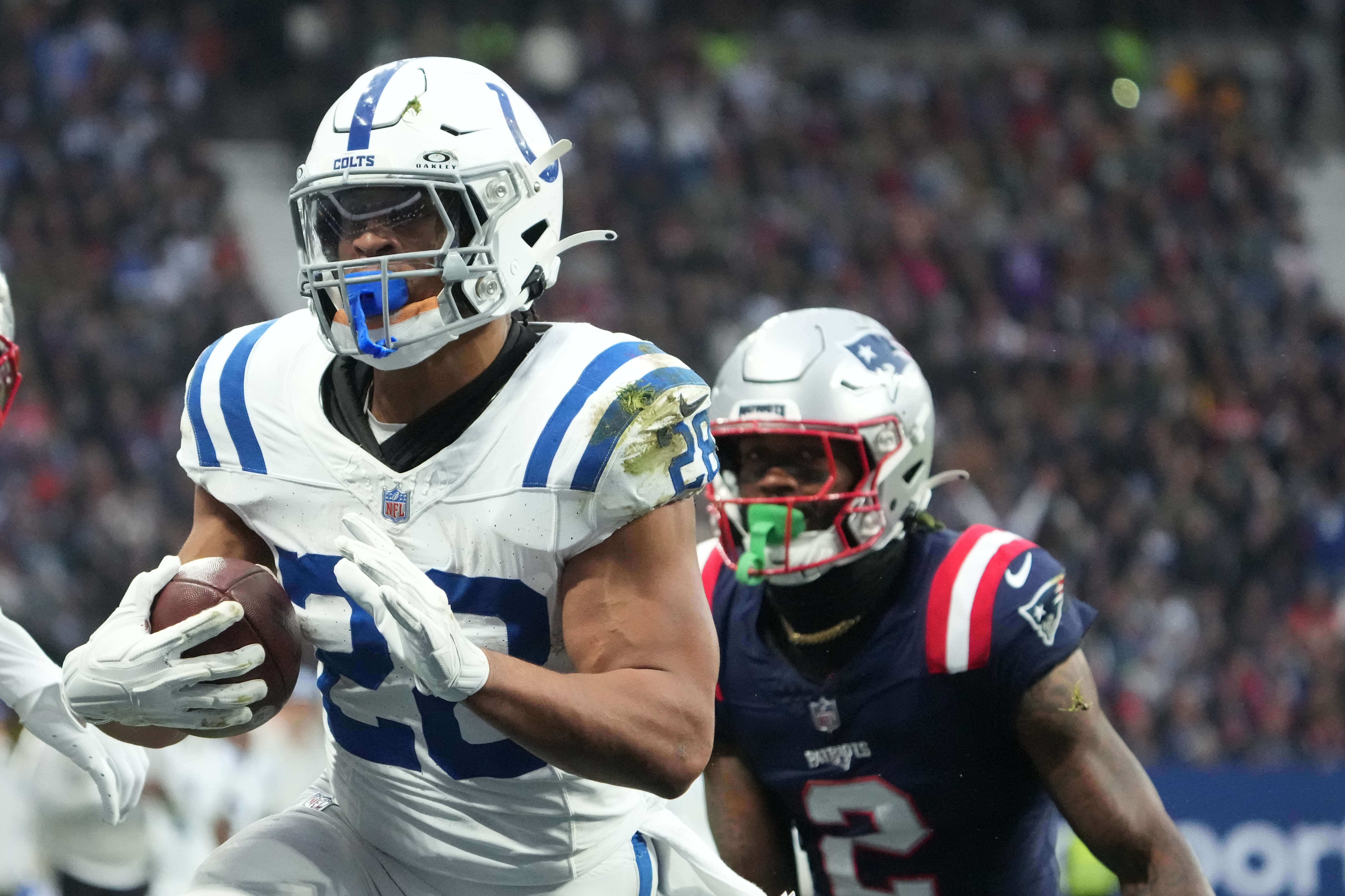 Nov 12, 2023; Frankfurt, Germany; Indianapolis Colts running back Jonathan Taylor (28) scores on a 1-yard touchdown run against New England Patriots cornerback Jalen Mills (2) in the first half during an NFL International Series game at Deutsche Bank Park.