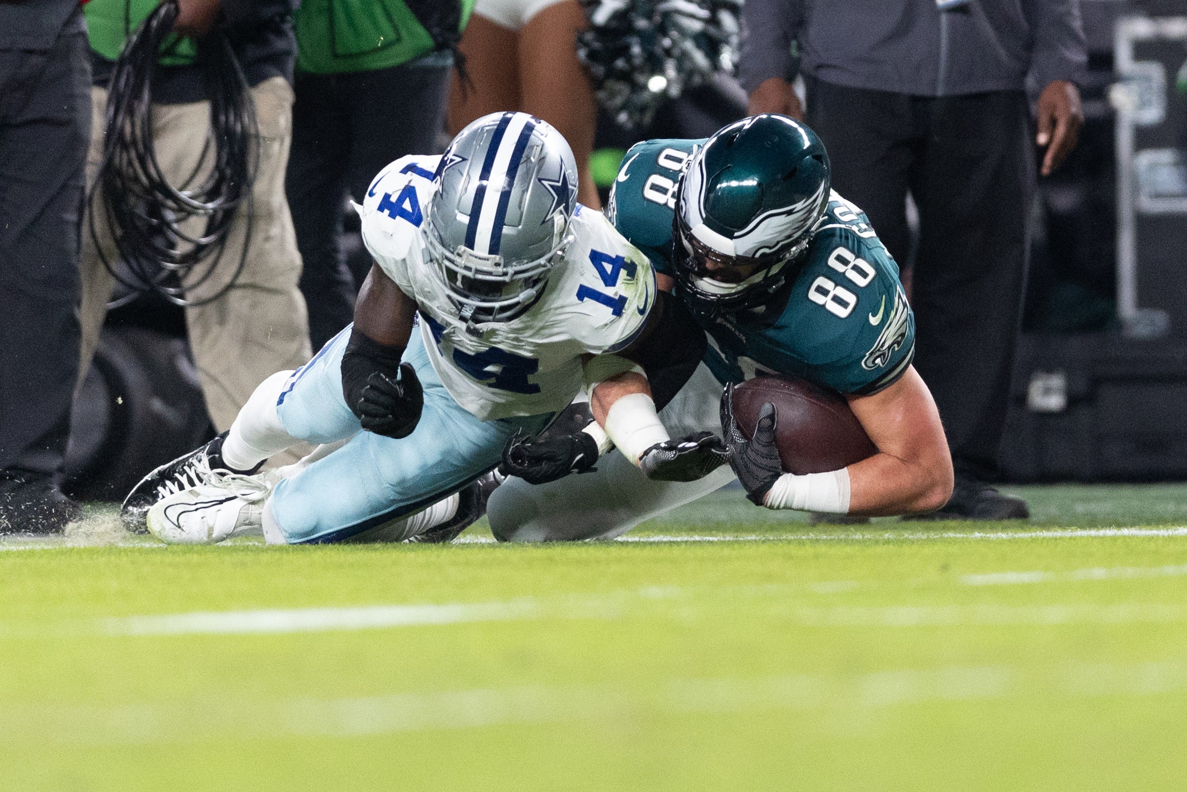 Dallas Cowboys safety Markquese Bell (14) tackles Philadelphia Eagles tight end Dallas Goedert (88) at Lincoln Financial Field.