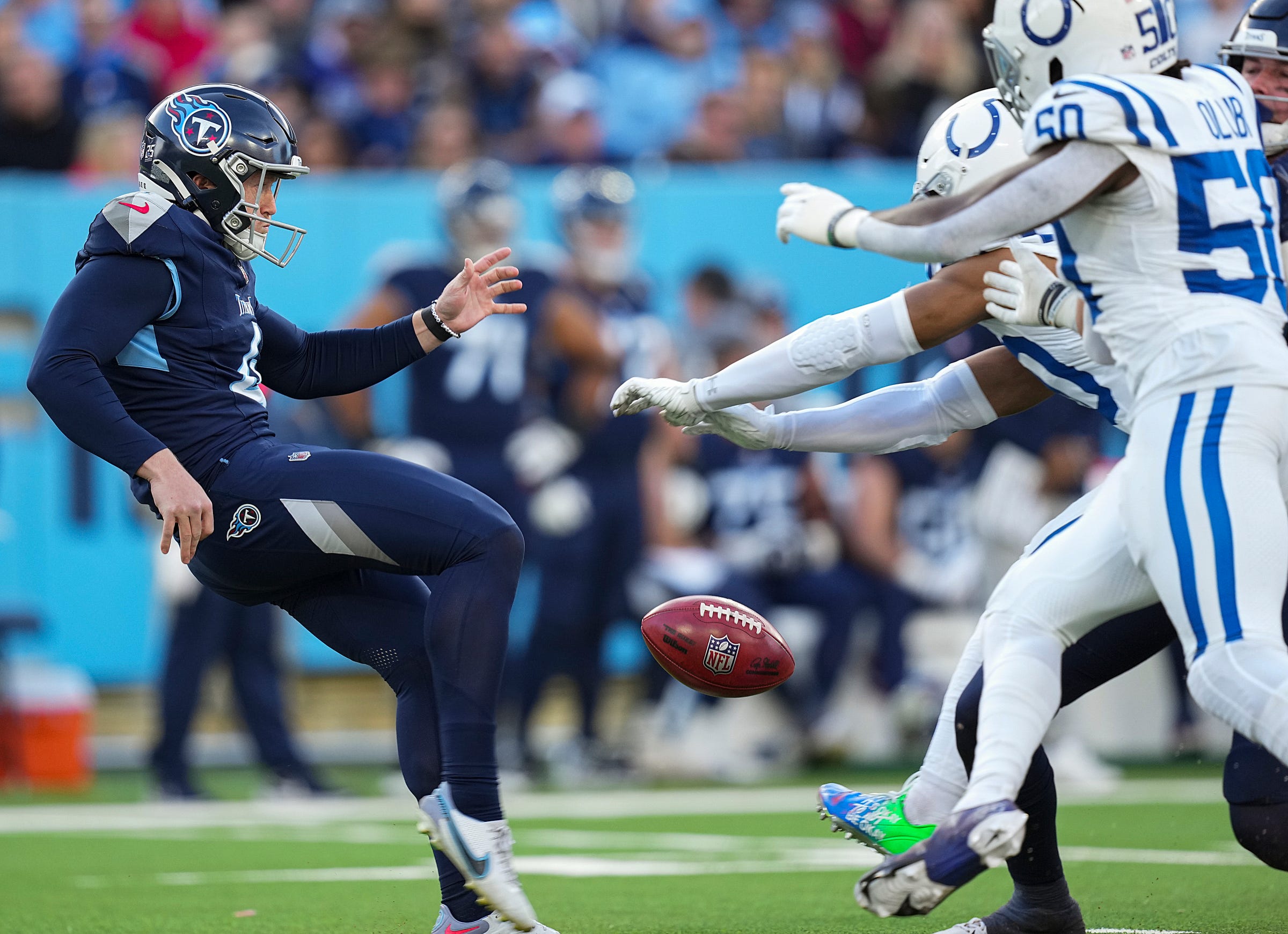 Indianapolis Colts safety Nick Cross (20) and teammates block a punt by Tennessee Titans punter Ryan Stonehouse (4) on Sunday, Dec. 3, 2023, at Nissan Stadium in Nashville, Tenn. Indianapolis Colts linebacker Grant Stuard (41) recovered the ball and ran in a touchdown.