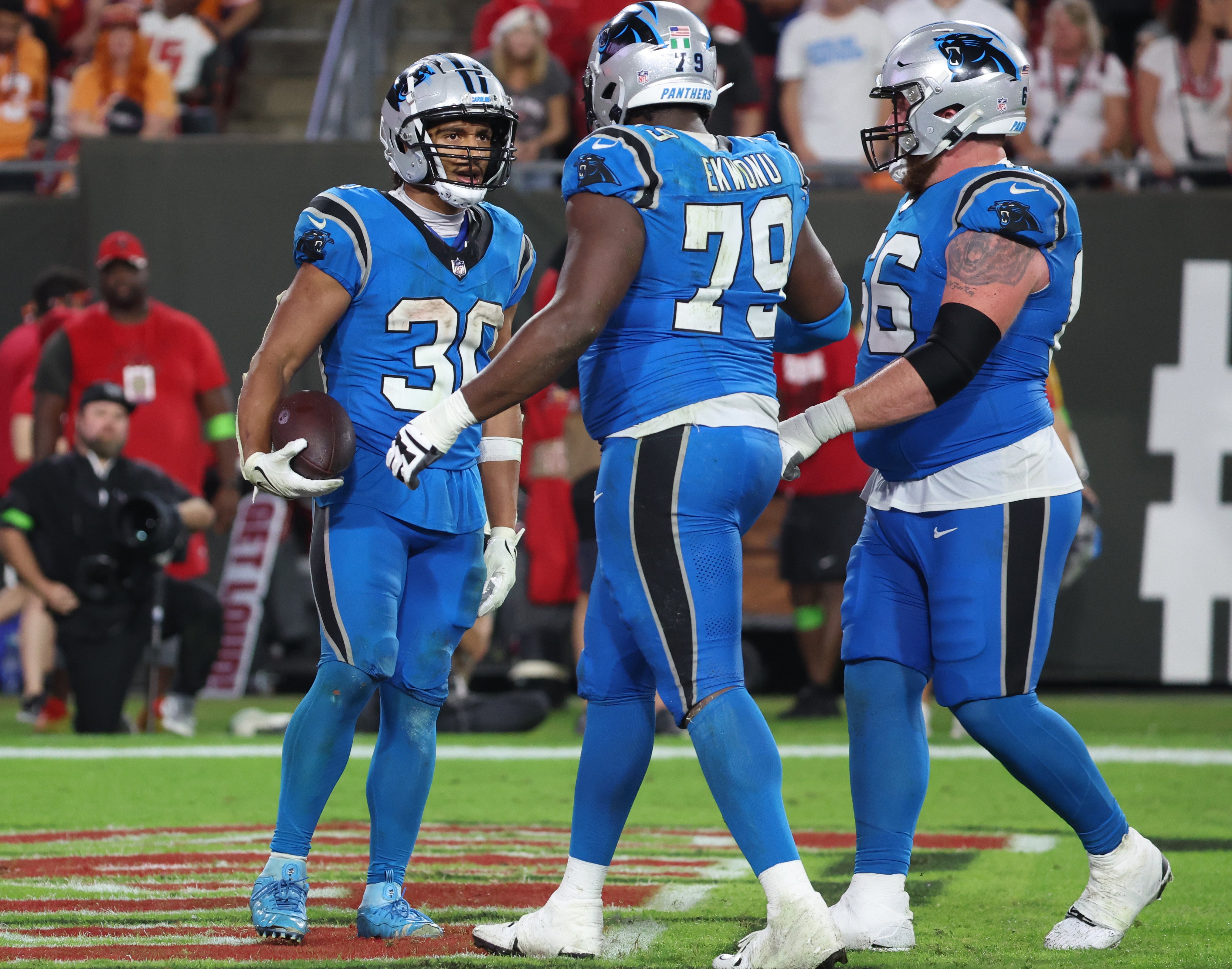 Dec 3, 2023; Tampa, Florida, USA; Carolina Panthers running back Chuba Hubbard (30) is congratulated after he scored a touchdown against the Tampa Bay Buccaneers during the second half at Raymond James Stadium. Mandatory Credit: Kim Klement Neitzel-USA TODAY Sports