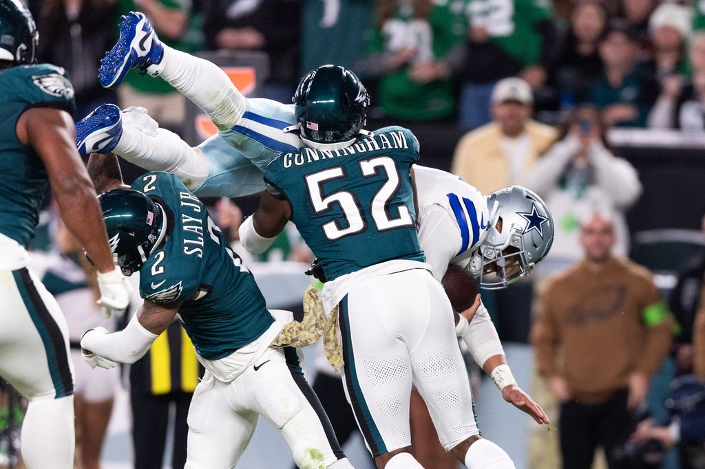 Philadelphia Eagles linebacker Zach Cunningham (52) and cornerback Darius Slay (2) tackle Dallas Cowboys quarterback Dak Prescott (4) short of the goaline during the fourth quarter at Lincoln Financial Field.