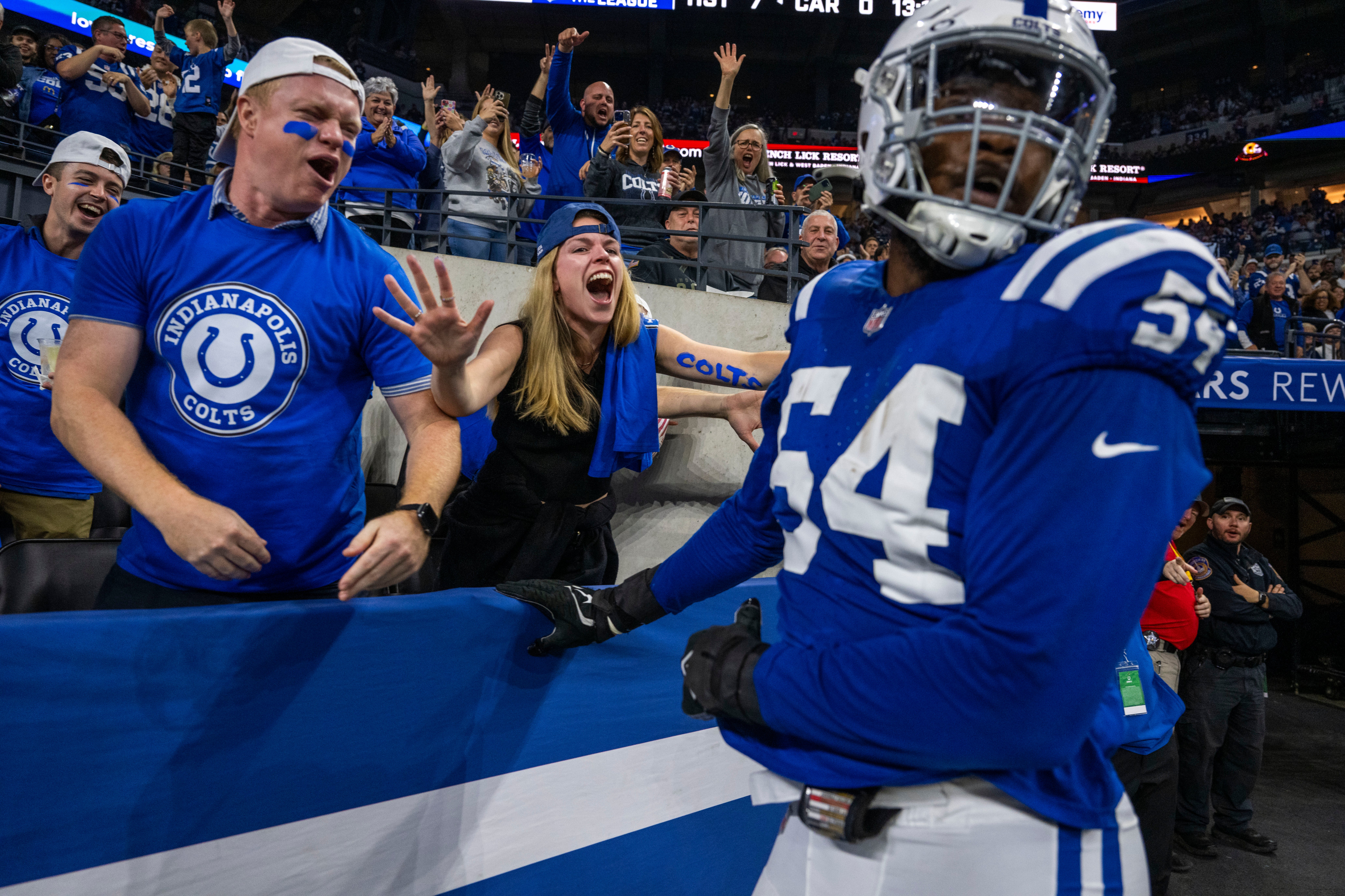 Oct 29, 2023; Indianapolis, Indiana, USA; Indianapolis Colts defensive end Dayo Odeyingbo (54) celebrates a touchdown with some fans during the first half against the New Orleans Saints at Lucas Oil Stadium.