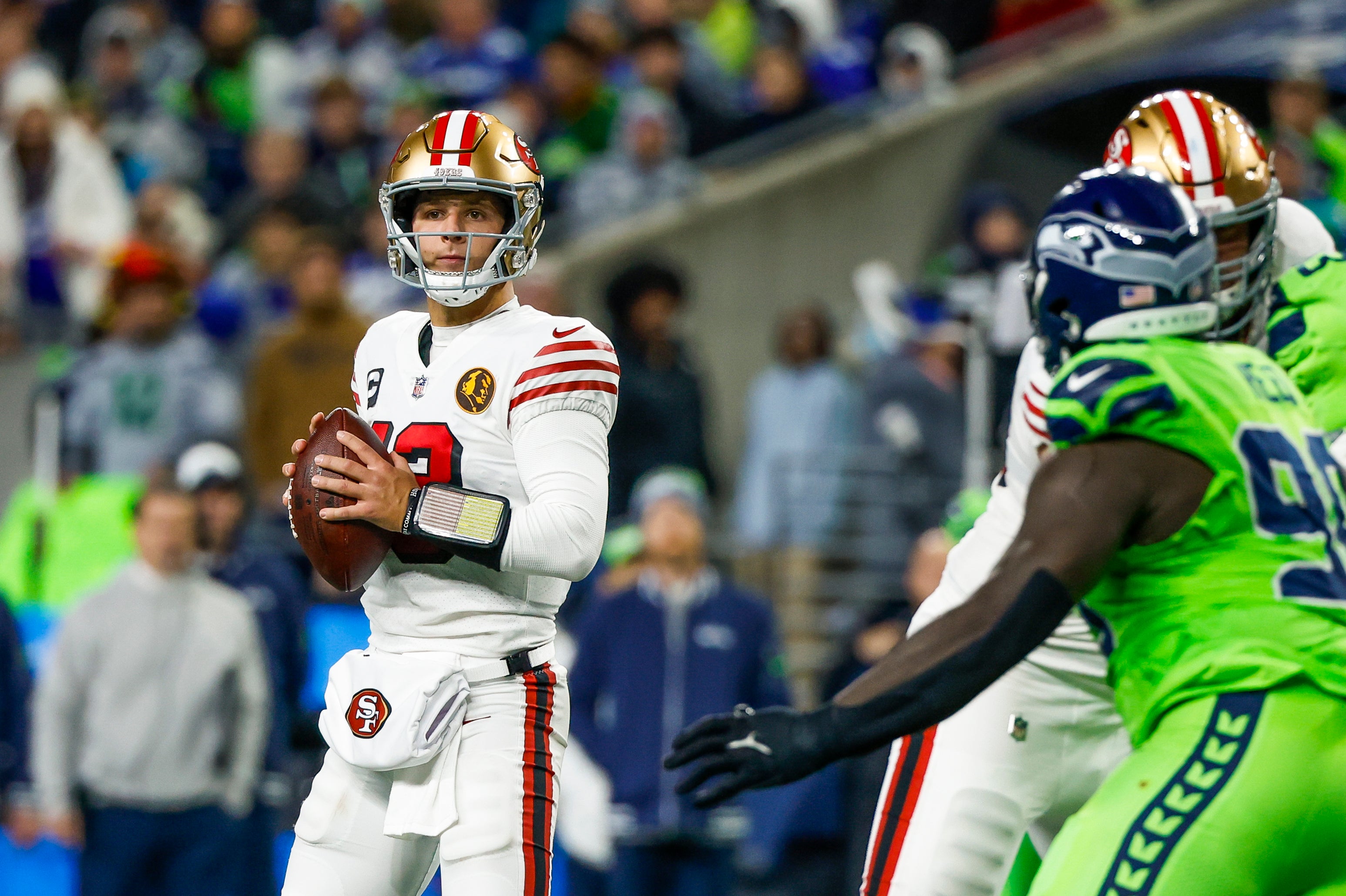Nov 23, 2023; Seattle, Washington, USA; San Francisco 49ers quarterback Brock Purdy (13) looks to pass against the Seattle Seahawks during the second quarter at Lumen Field.