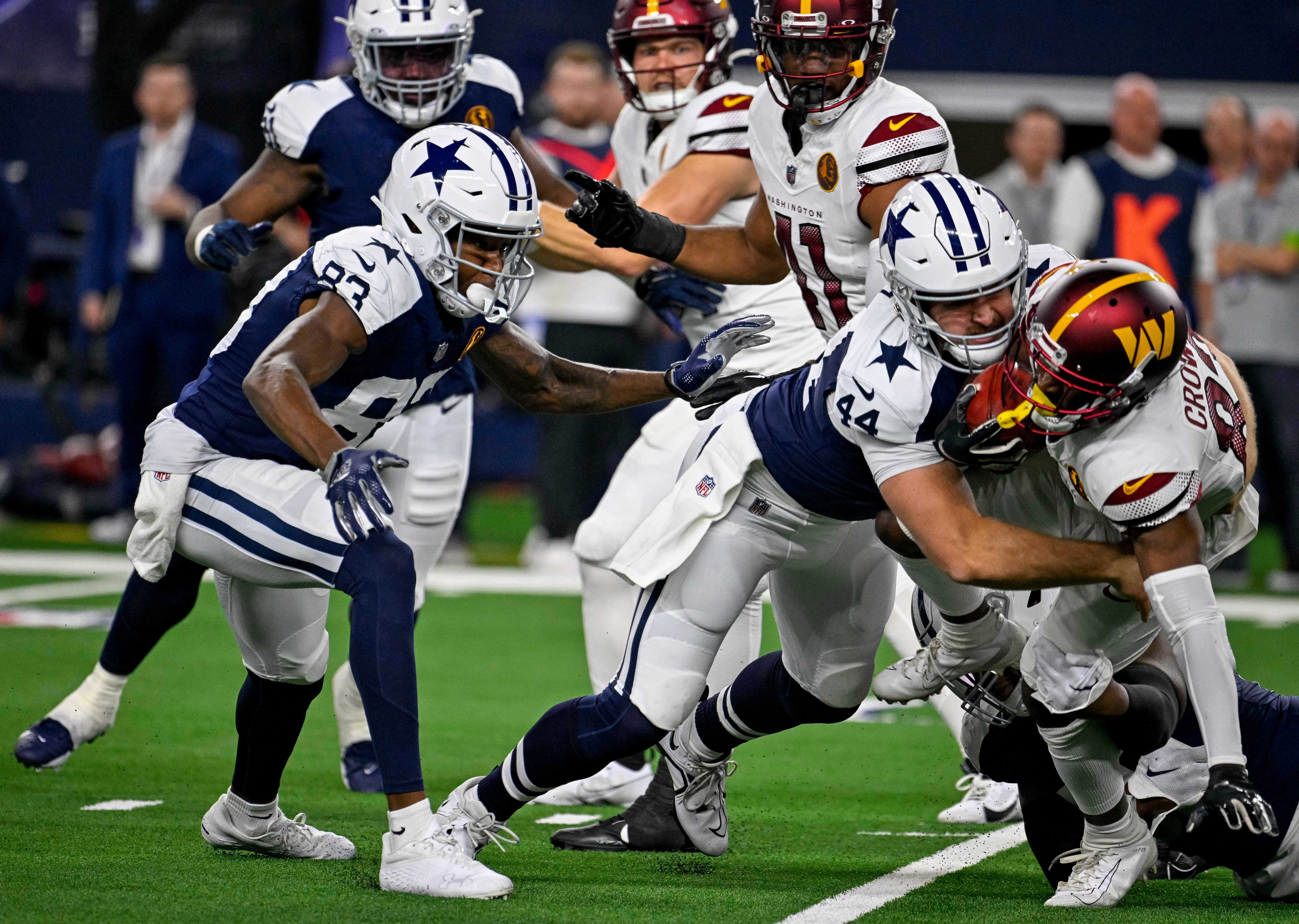 Dallas Cowboys wide receiver Jalen Brooks (83) and long snapper Trent Sieg (44) and Washington Commanders wide receiver Jamison Crowder (83) in action during the game between the Dallas Cowboys and the Washington Commanders at AT&T Stadium.