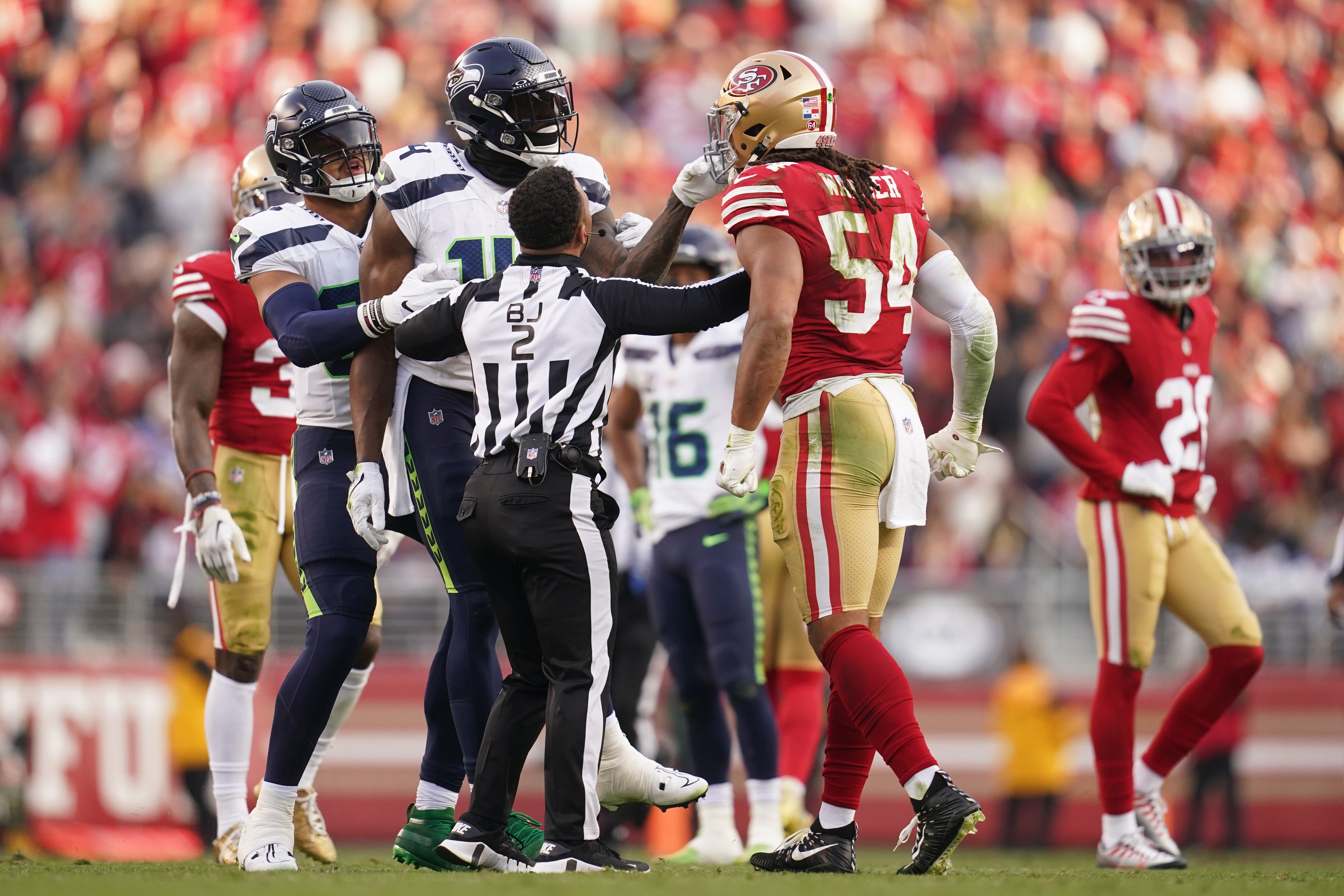 Dec 10, 2023; Santa Clara, California, USA; Seattle Seahawks wide receiver DK Metcalf (14) grabs the face mask of San Francisco 49ers linebacker Fred Warner (54) after the end of play in the fourth quarter at Levi's Stadium.
