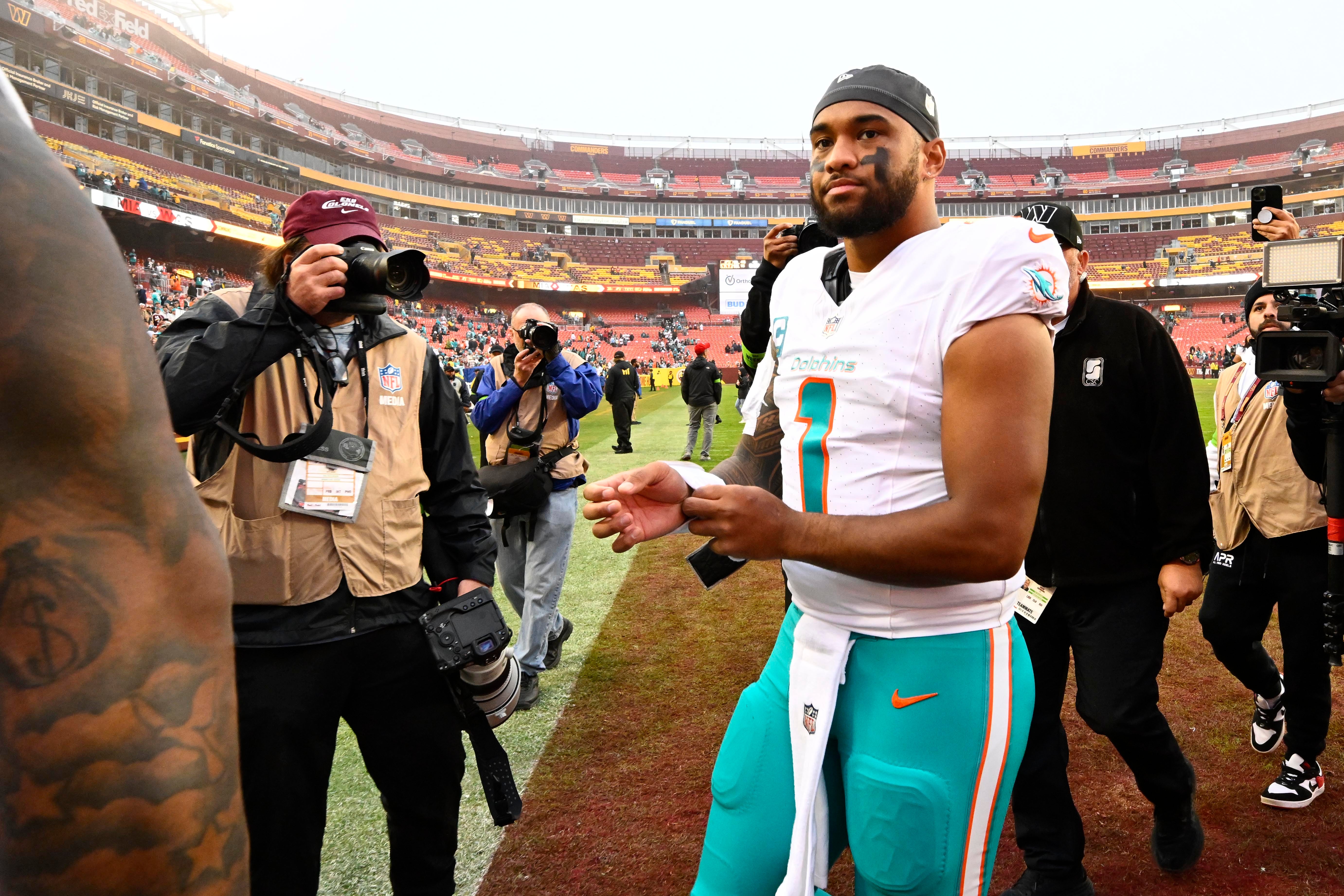 Dec 3, 2023; Landover, Maryland, USA; Miami Dolphins quarterback Tua Tagovailoa (1) walks off the field after the game against the Washington Commanders at FedExField. Mandatory Credit: Brad Mills-USA TODAY Sports