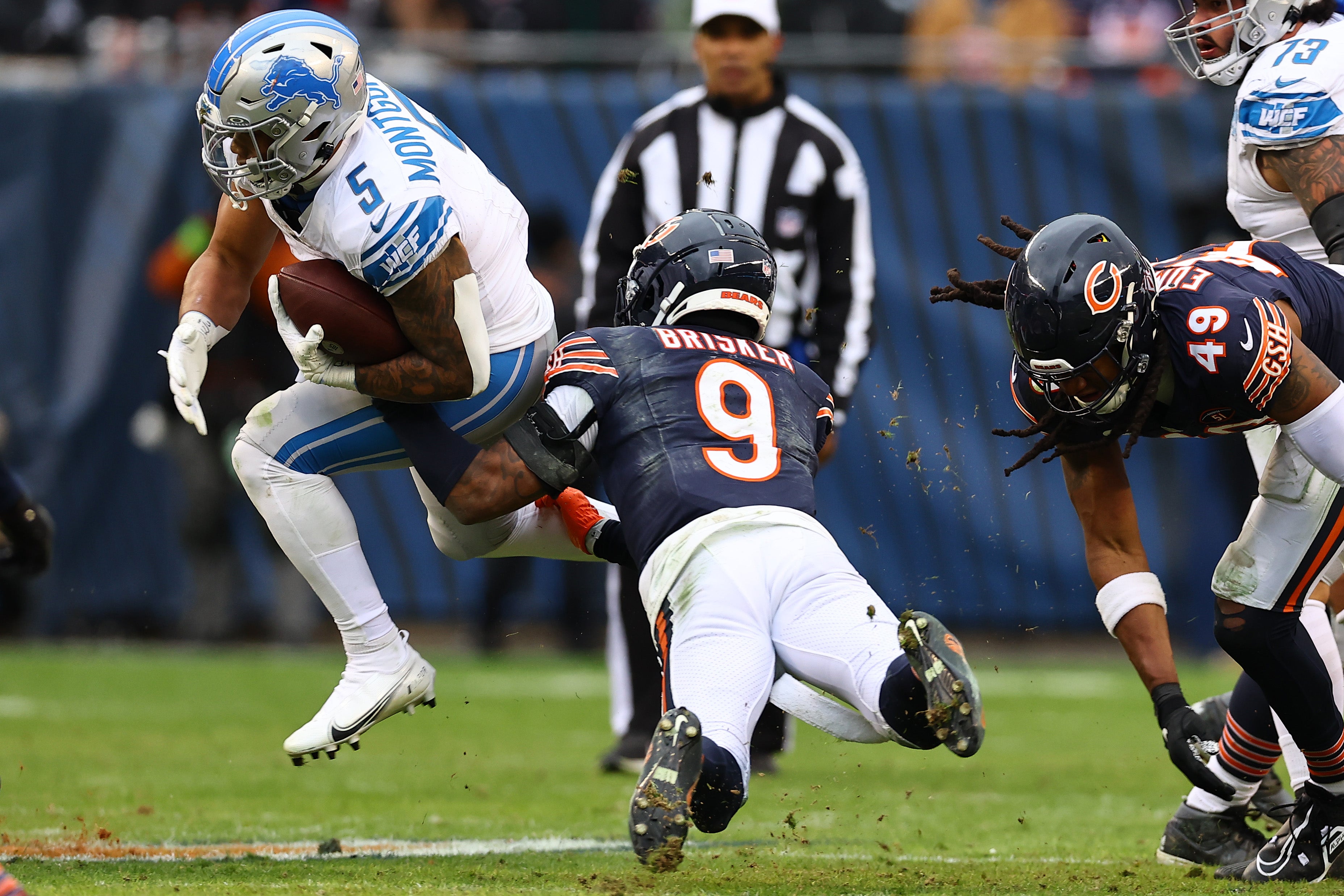 Dec 10, 2023; Chicago, Illinois, USA; Chicago Bears safety Jaquan Brisker (9) makes a tackle on Detroit Lions running back David Montgomery (5) during the second half at Soldier Field.