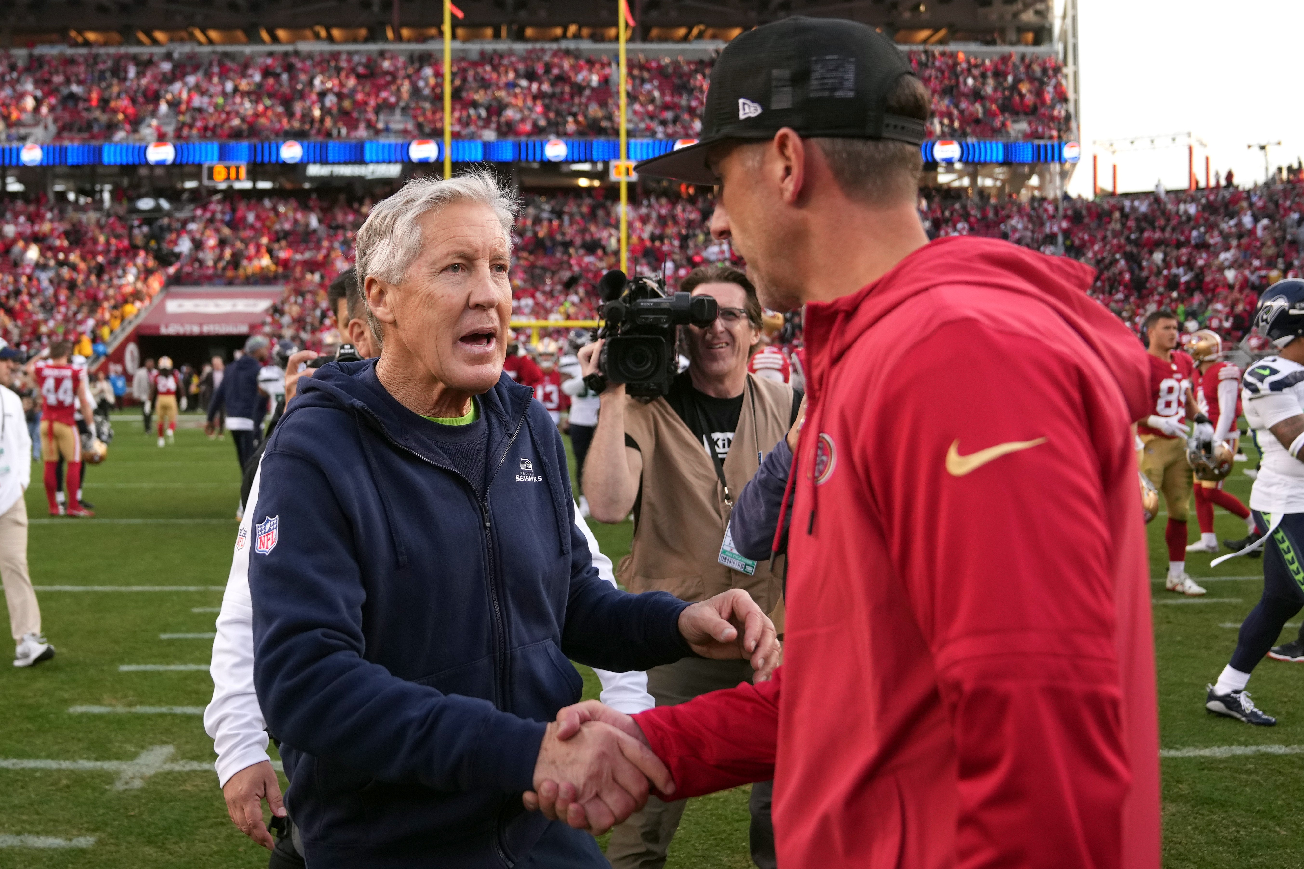 Dec 10, 2023; Santa Clara, California, USA; Seattle Seahawks head coach Pete Carroll (left) shakes hands with San Francisco 49ers head coach Kyle Shanahan (right) after the game at Levi's Stadium.