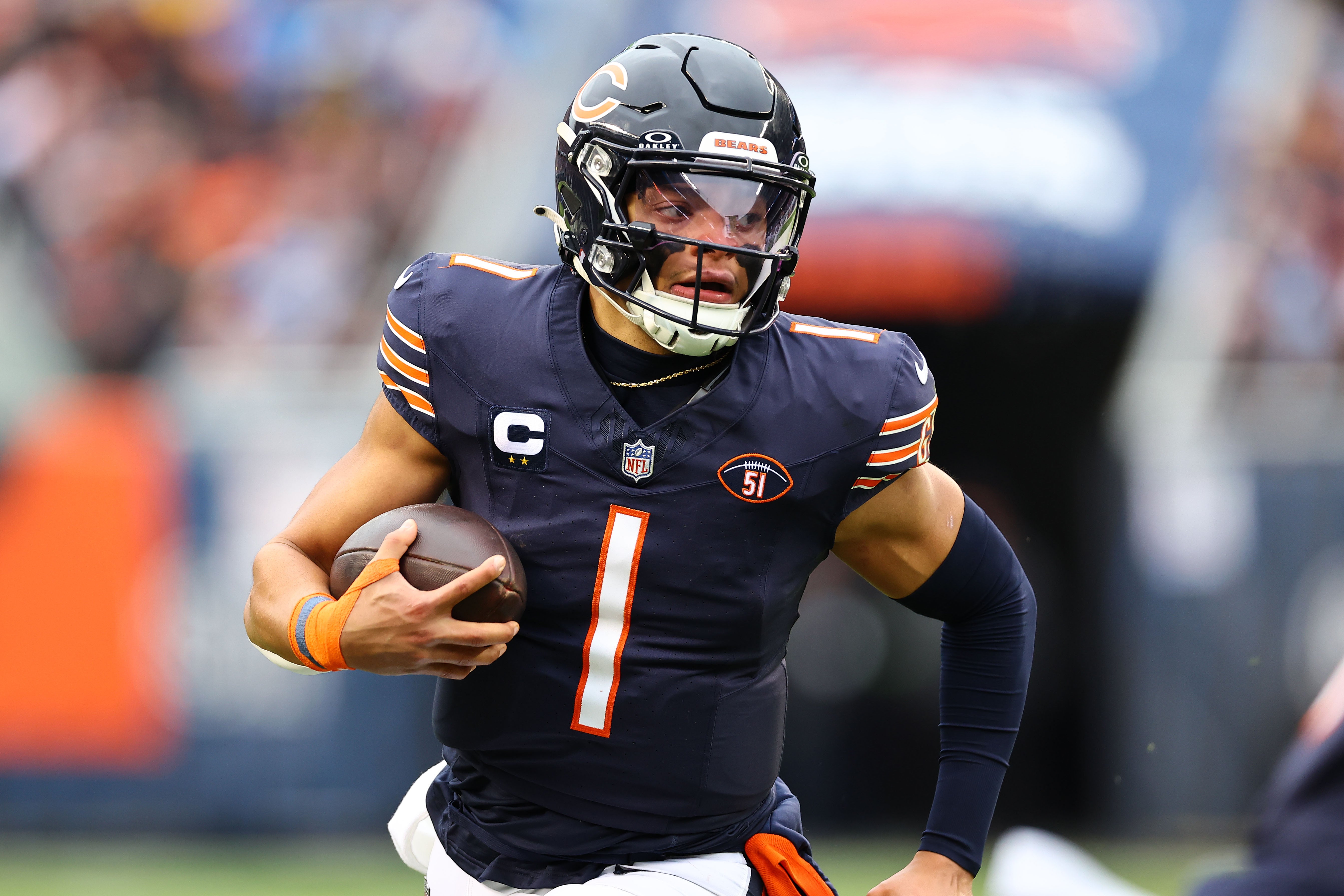 Dec 10, 2023; Chicago, Illinois, USA; Chicago Bears quarterback Justin Fields (1) rushes the ball against the Detroit Lions during the first half at Soldier Field.