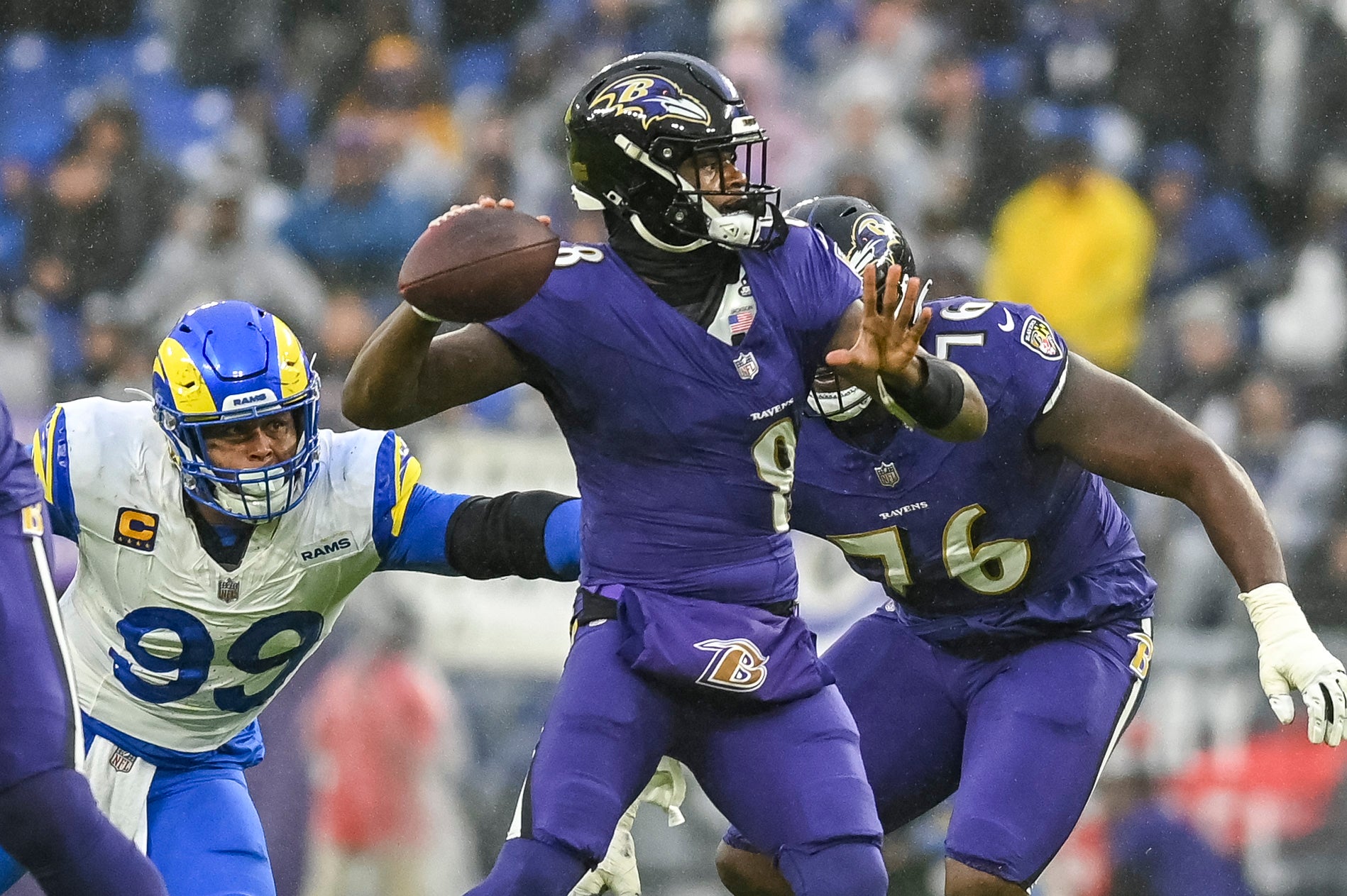 Los Angeles Rams defensive tackle Aaron Donald (99) grabs Baltimore Ravens quarterback Lamar Jackson (8) jersey while he throws during the first half at M&T Bank Stadium. Mandatory Credit: Tommy Gilligan-USA TODAY Sports