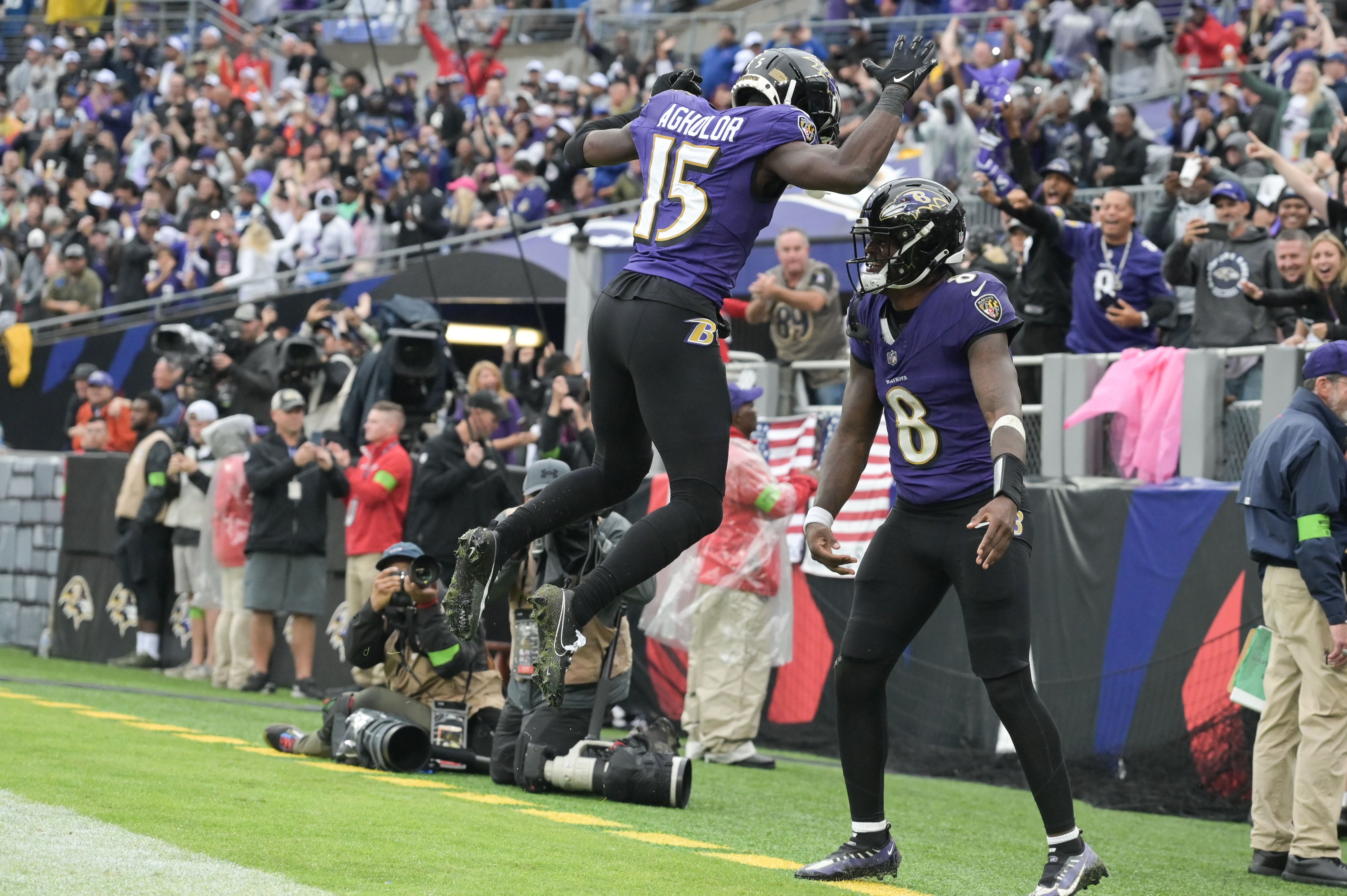 Baltimore Ravens quarterback Lamar Jackson (8) celebrates with a leaping wide receiver Nelson Agholor (15) after scoring a touchdown during the third quarter against the Indianapolis Colts at M&T Bank Stadium.