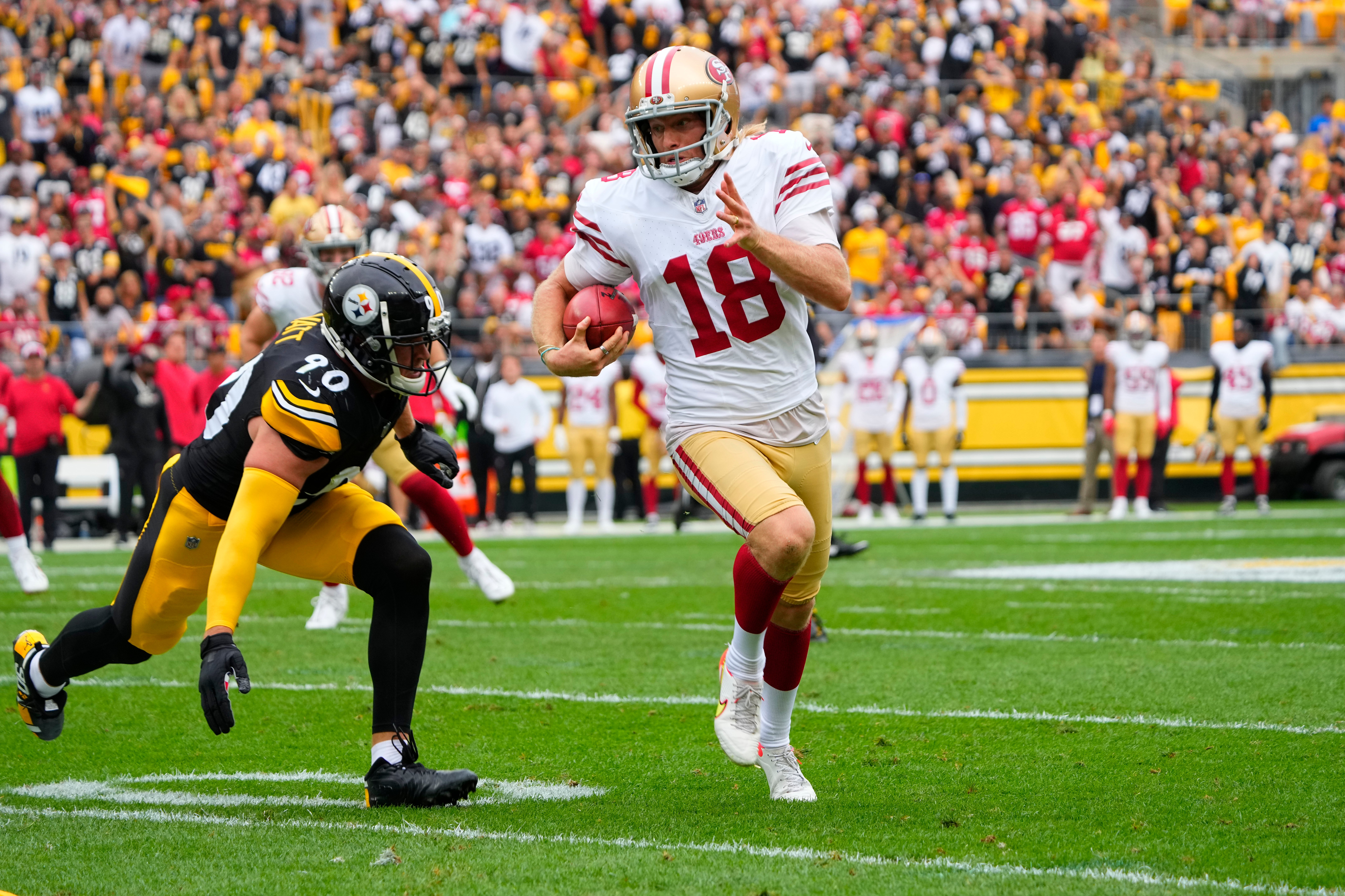 Sep 10, 2023; Pittsburgh, Pennsylvania, USA; San Francisco 49ers punter Mitch Wishnowsky (18) runs with the ball after a blocked field goal attempt with Pittsburgh Steelers linebacker T.J. Watt (90) in pursuit during the first half at Acrisure Stadium.