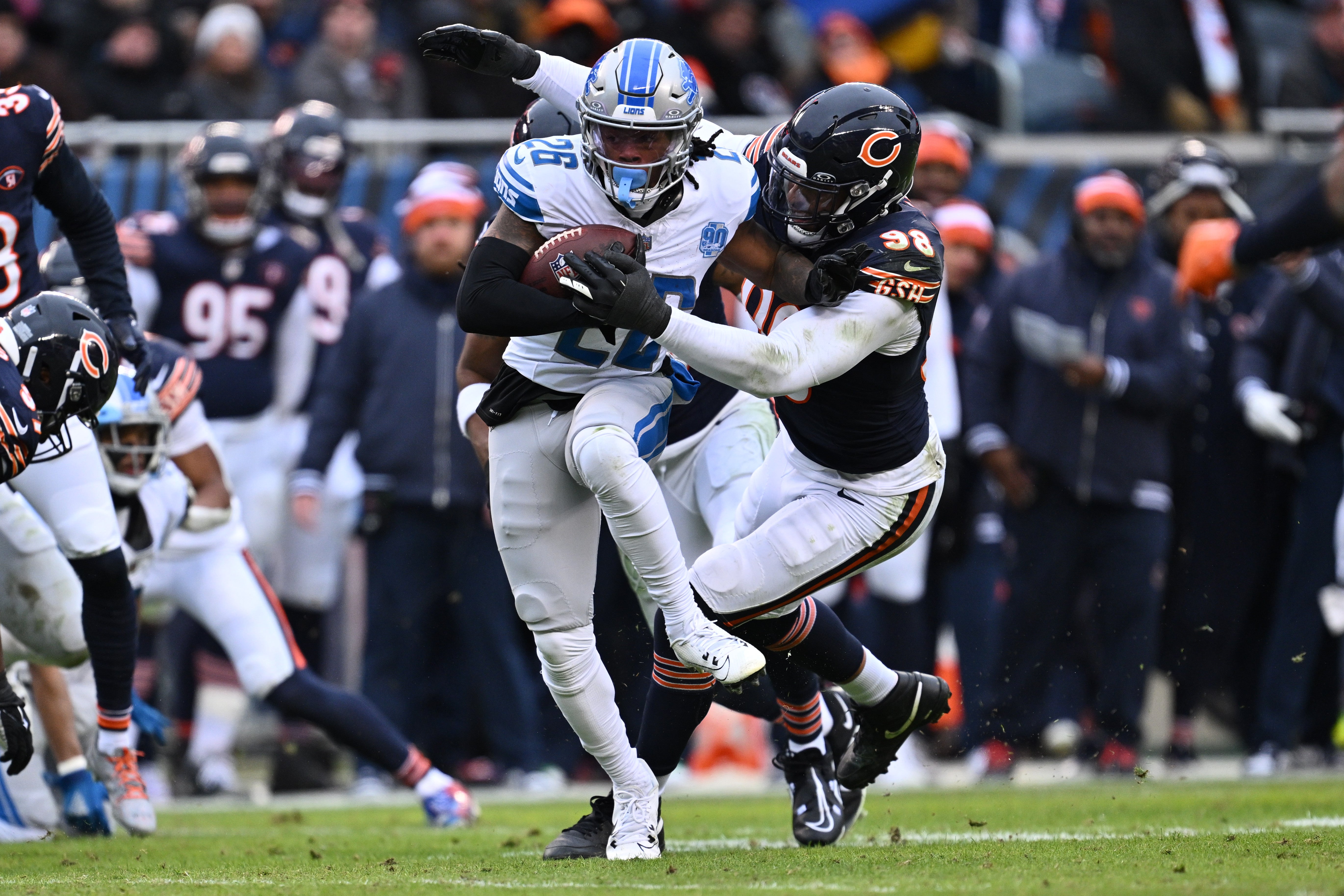 Dec 10, 2023; Chicago, Illinois, USA; Detroit Lions running back Jahmyr Gibbs (26) is dragged down by Chicago Bears defensive lineman Montez Sweat (98) in the first half at Soldier Field.
