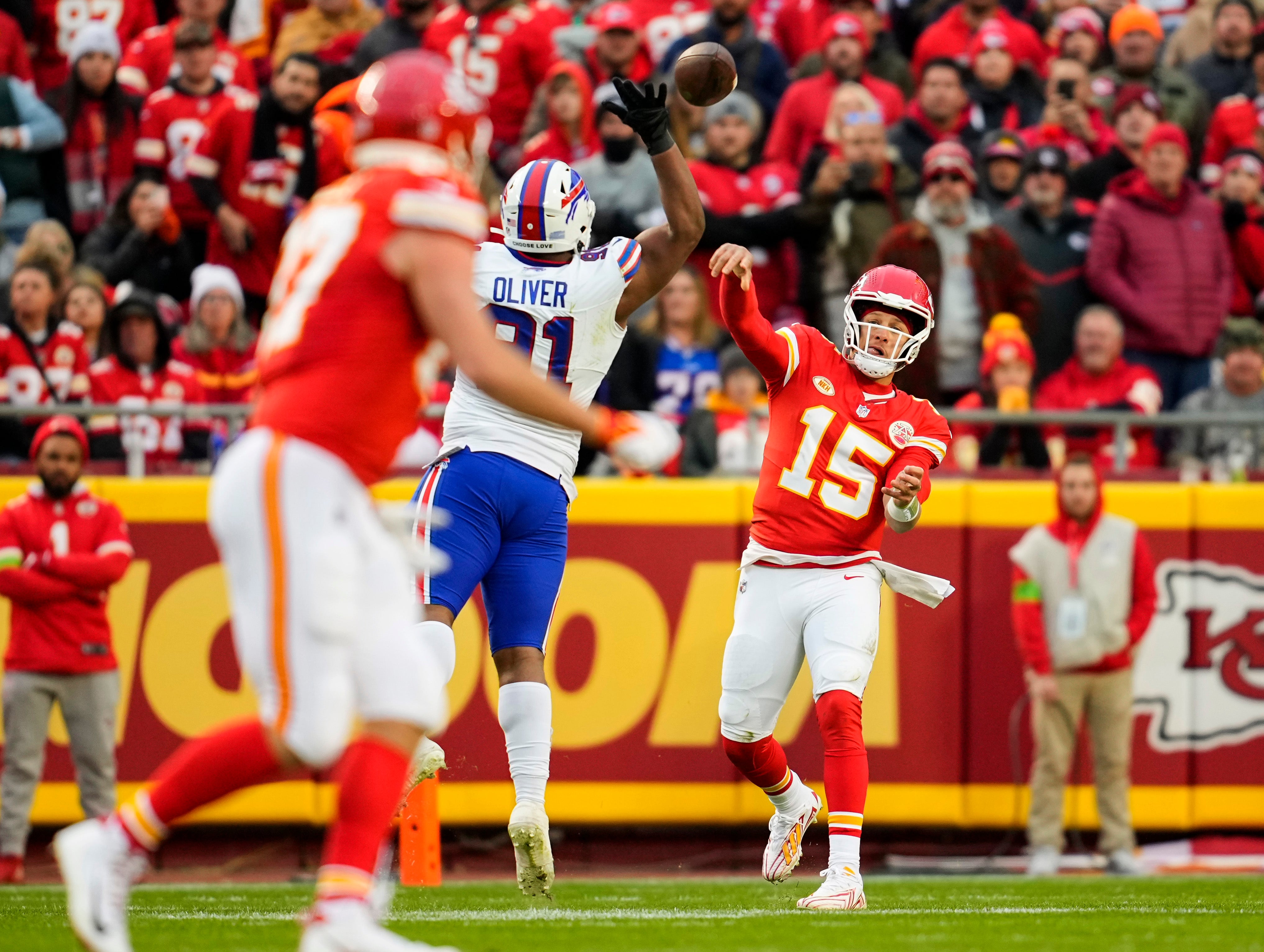 Kansas City Chiefs quarterback Patrick Mahomes throws a pass to tight end Travis Kelce as Buffalo Bills defensive tackle Ed Oliver defends during the first half at GEHA Field at Arrowhead Stadium