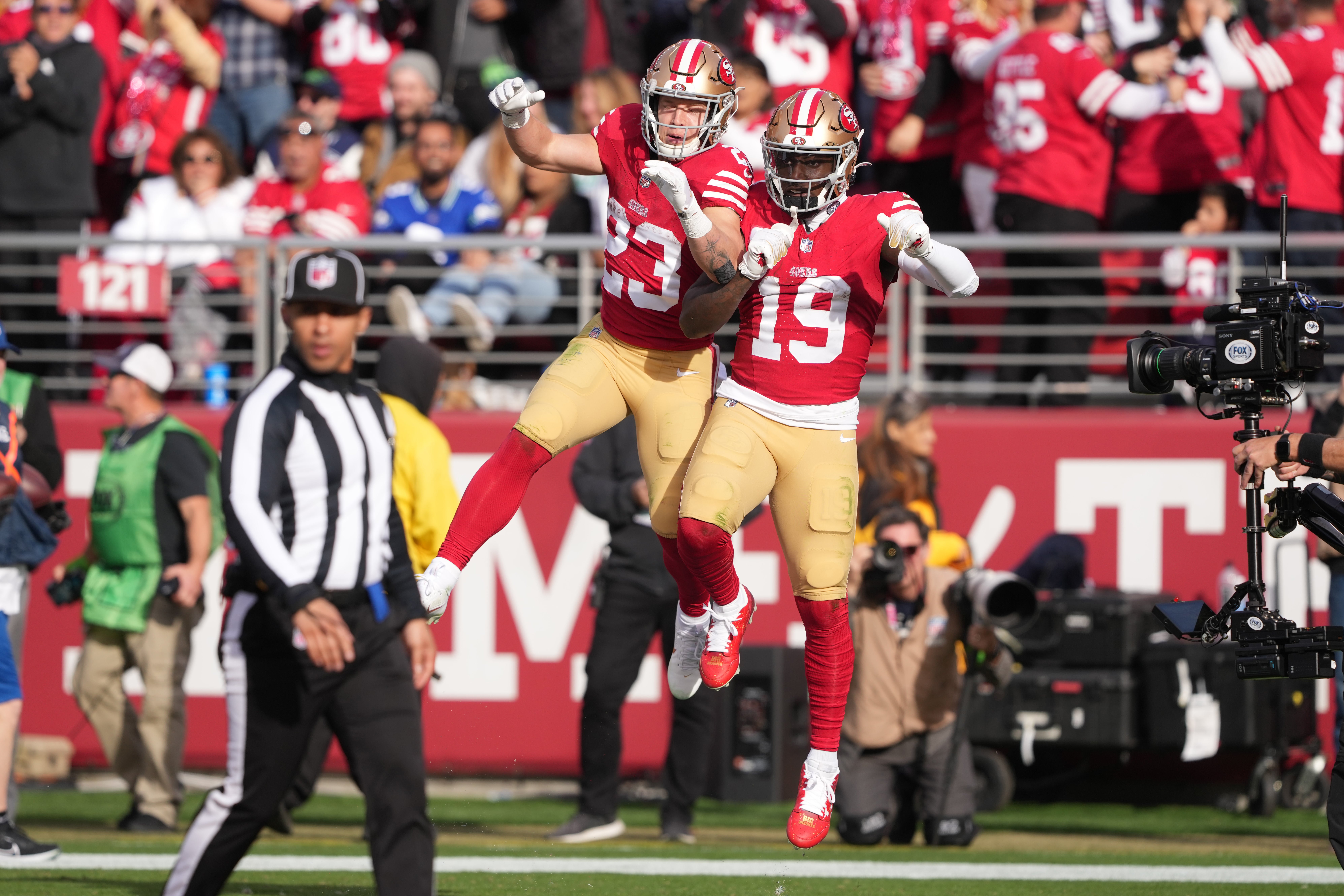 Dec 10, 2023; Santa Clara, California, USA; San Francisco 49ers wide receiver Deebo Samuel (19) celebrates with running back Christian McCaffrey (23) after scoring a touchdown against the Seattle Seahawks during the second quarter at Levi's Stadium.