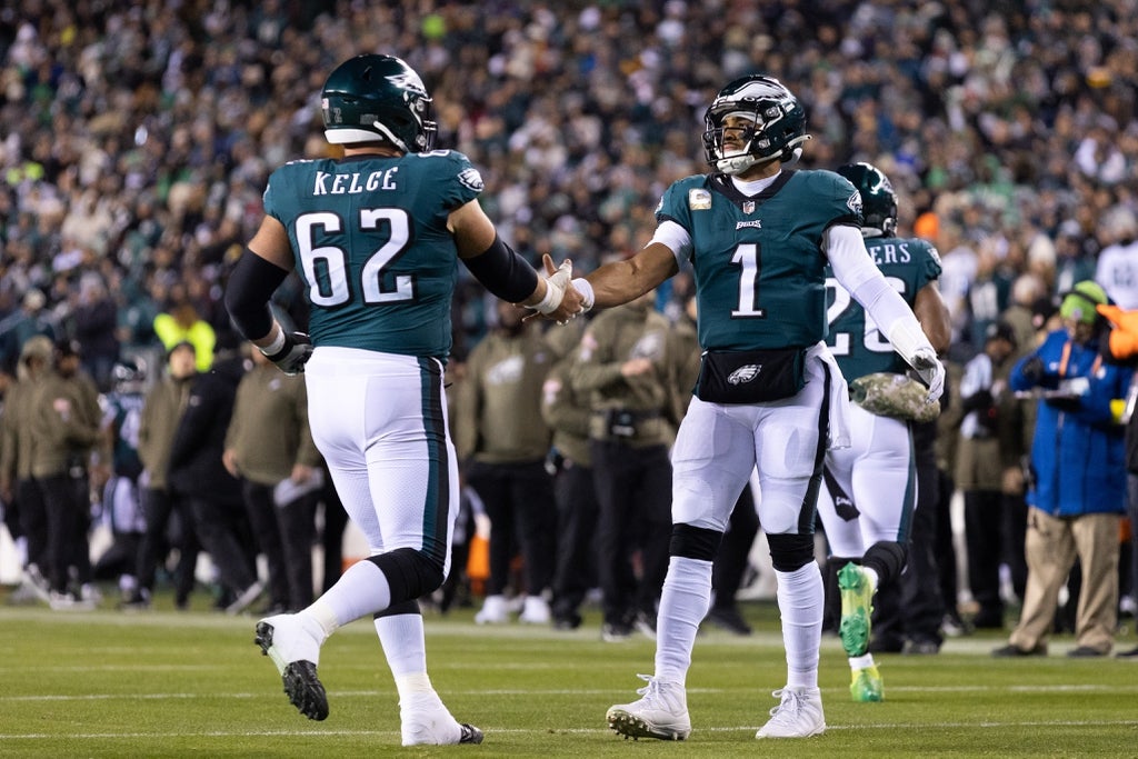 Philadelphia Eagles quarterback Jalen Hurts (1) and center Jason Kelce (62) in a game against the Washington Commanders at Lincoln Financial Field.