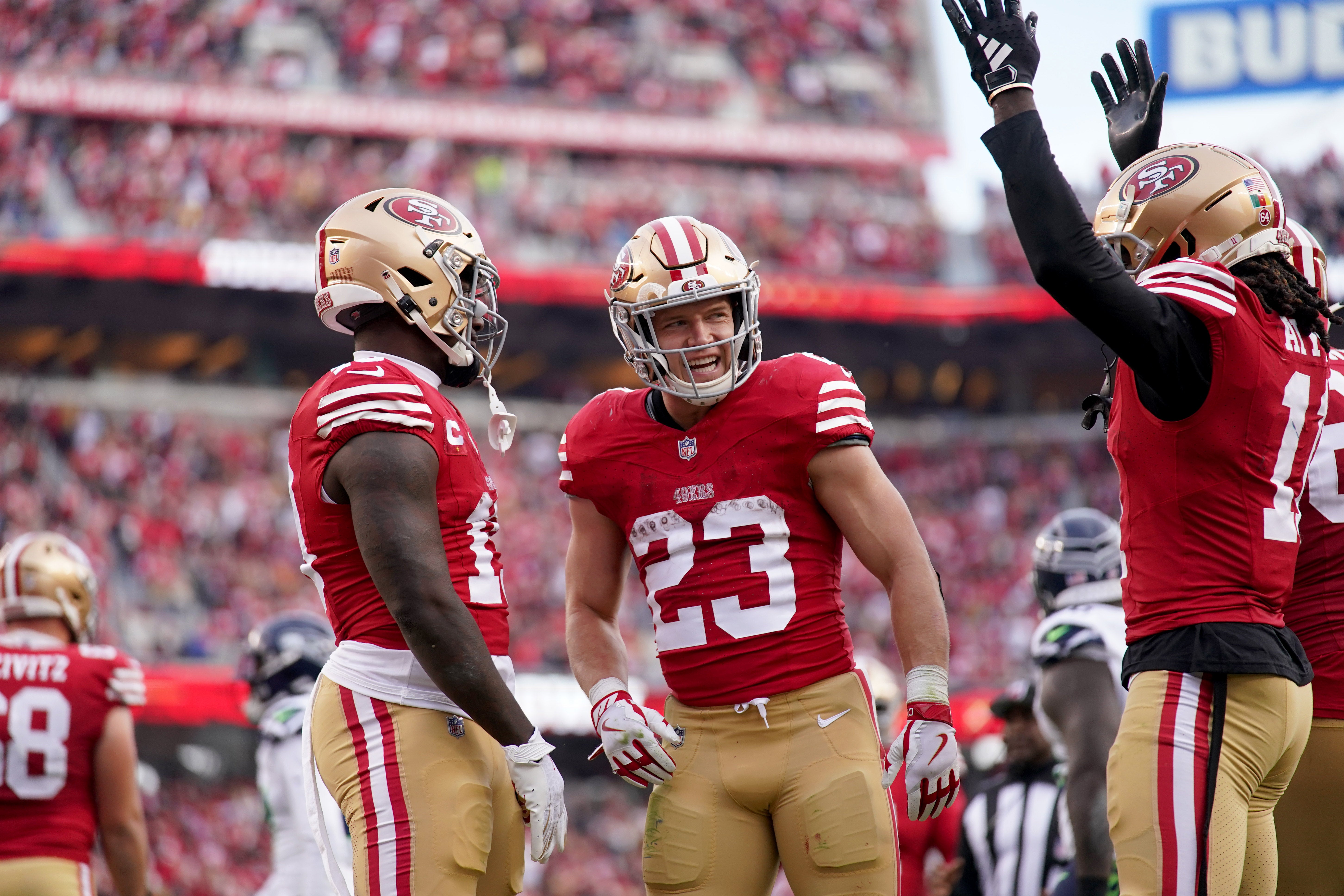 Dec 10, 2023; Santa Clara, California, USA; San Francisco 49ers running back Christian McCaffrey (23) stands next to wide receiver Deebo Samuel (19) and wide receiver Brandon Aiyuk (11) after the 49ers picked up a first down near the end zone against the Seattle Seahawks in the third quarter at Levi's Stadium.